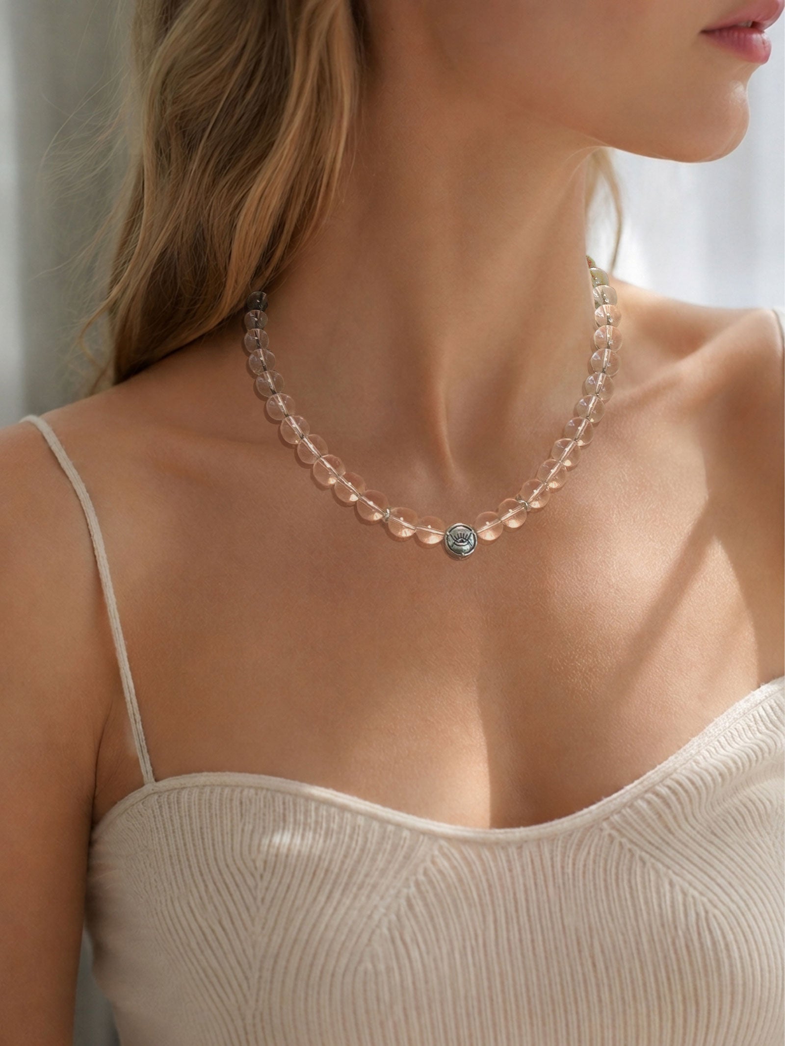Collector grade clear quartz necklace worn on model