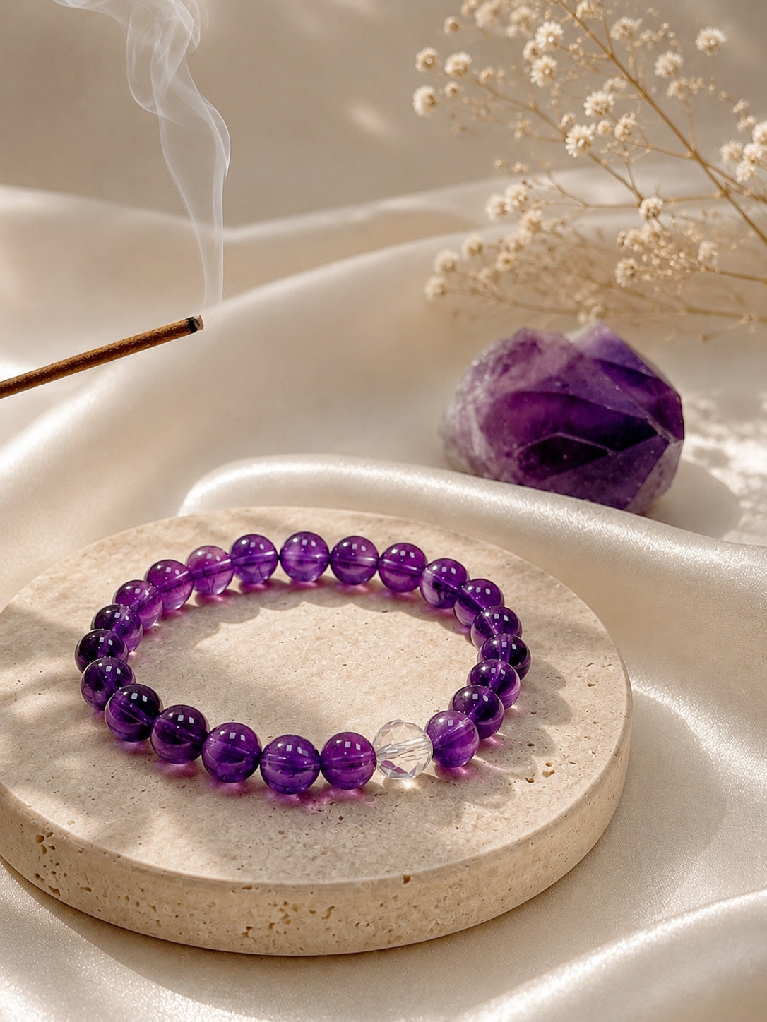 Amethyst bracelet styled on meditation altar for intuition, awareness, and inner clarity