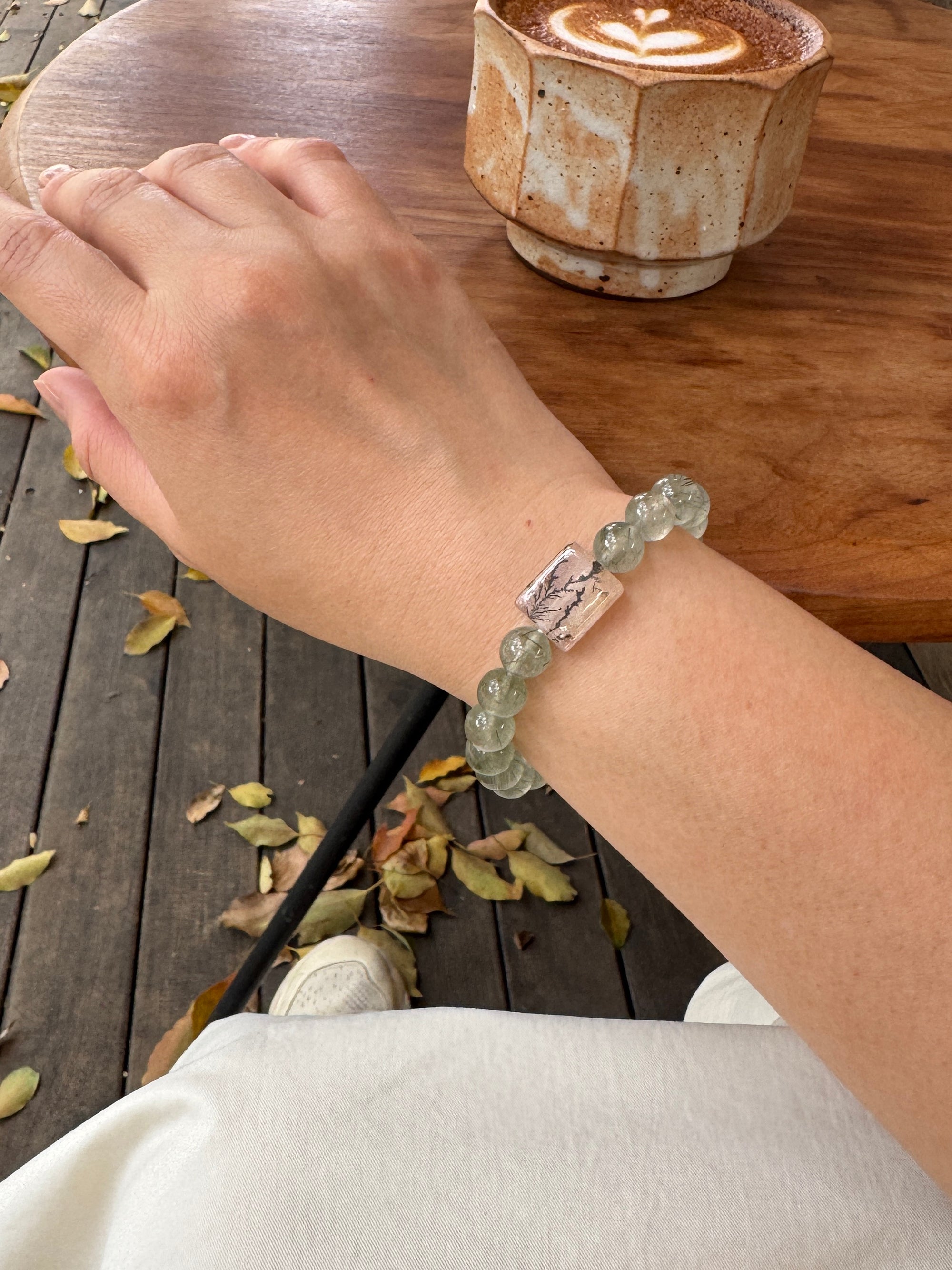 Green Rutilated Quartz crystal bracelet worn on wrist close-up for confidence and abundance
