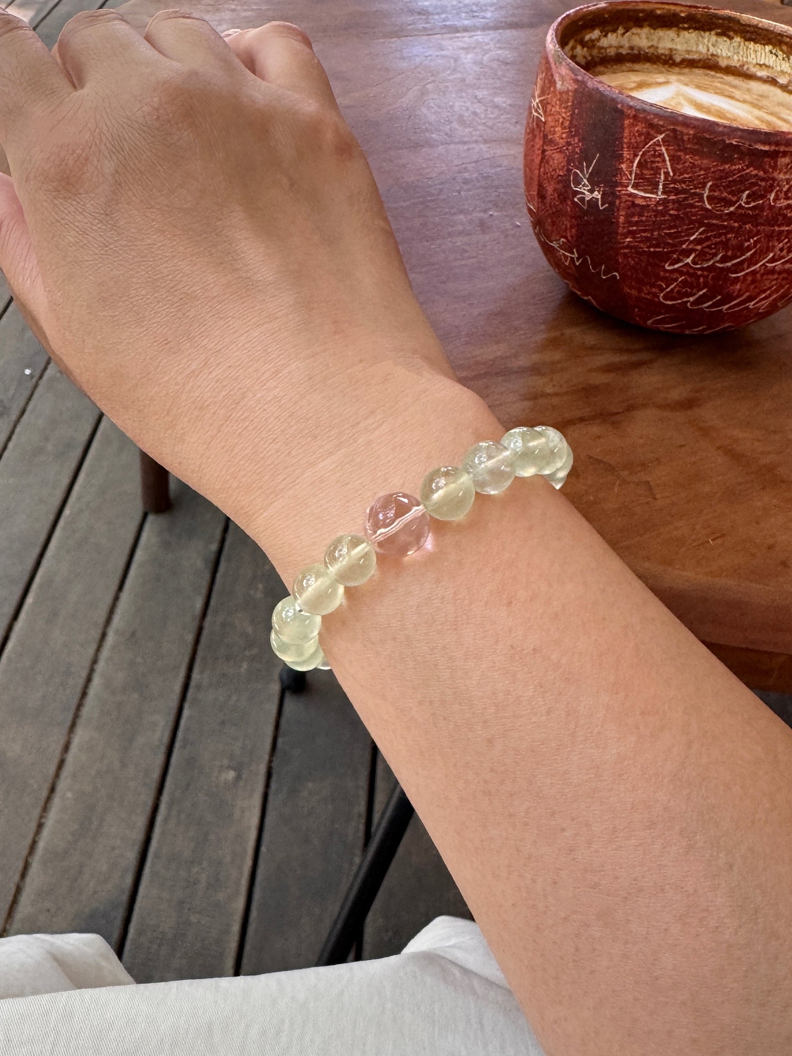 Prehnite crystal bracelet worn on wrist close-up for love and emotional connection