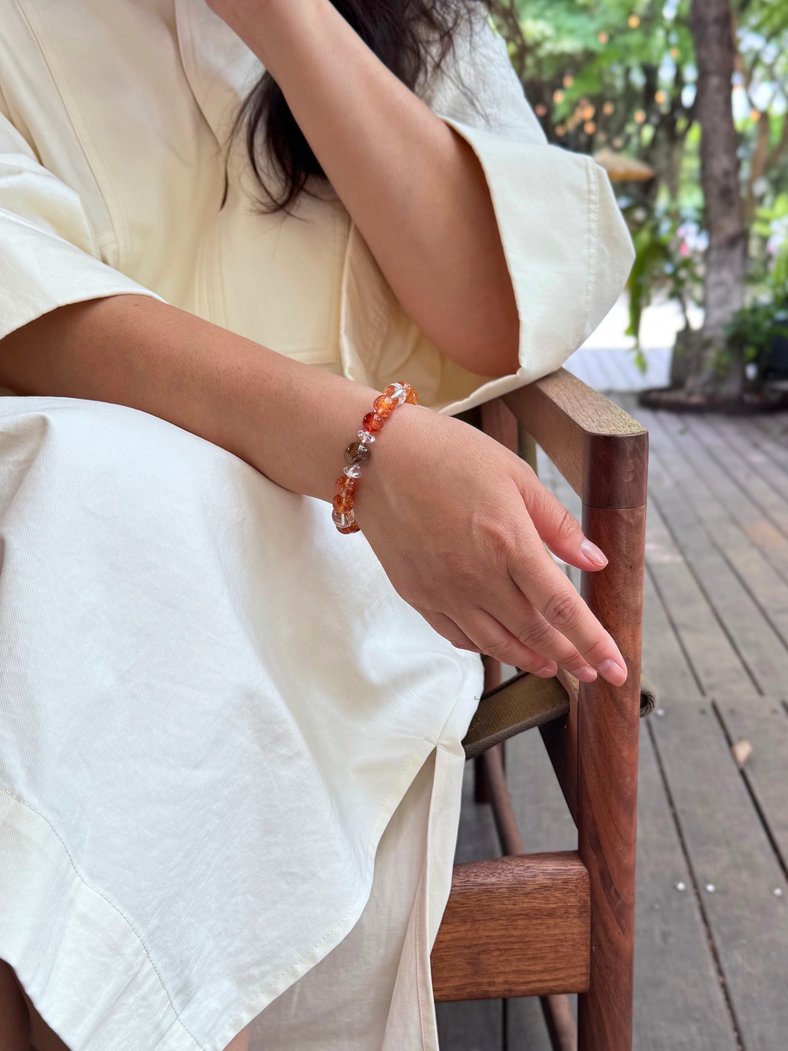 Red Flower Quartz crystal bracelet worn in a relaxed lifestyle setting for calm and balanced energy