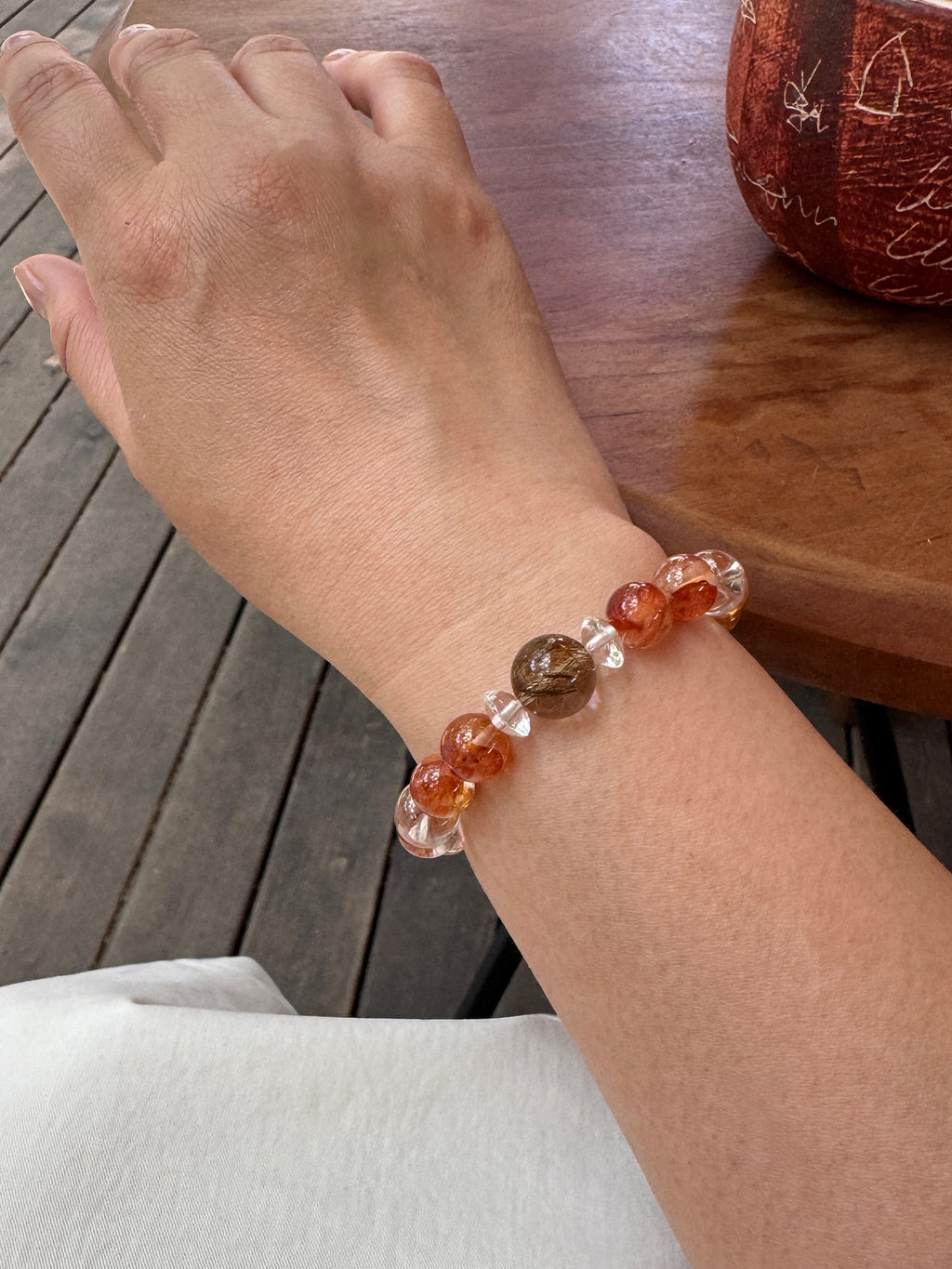 Red Flower Quartz crystal bracelet worn on wrist close-up showing size and fit