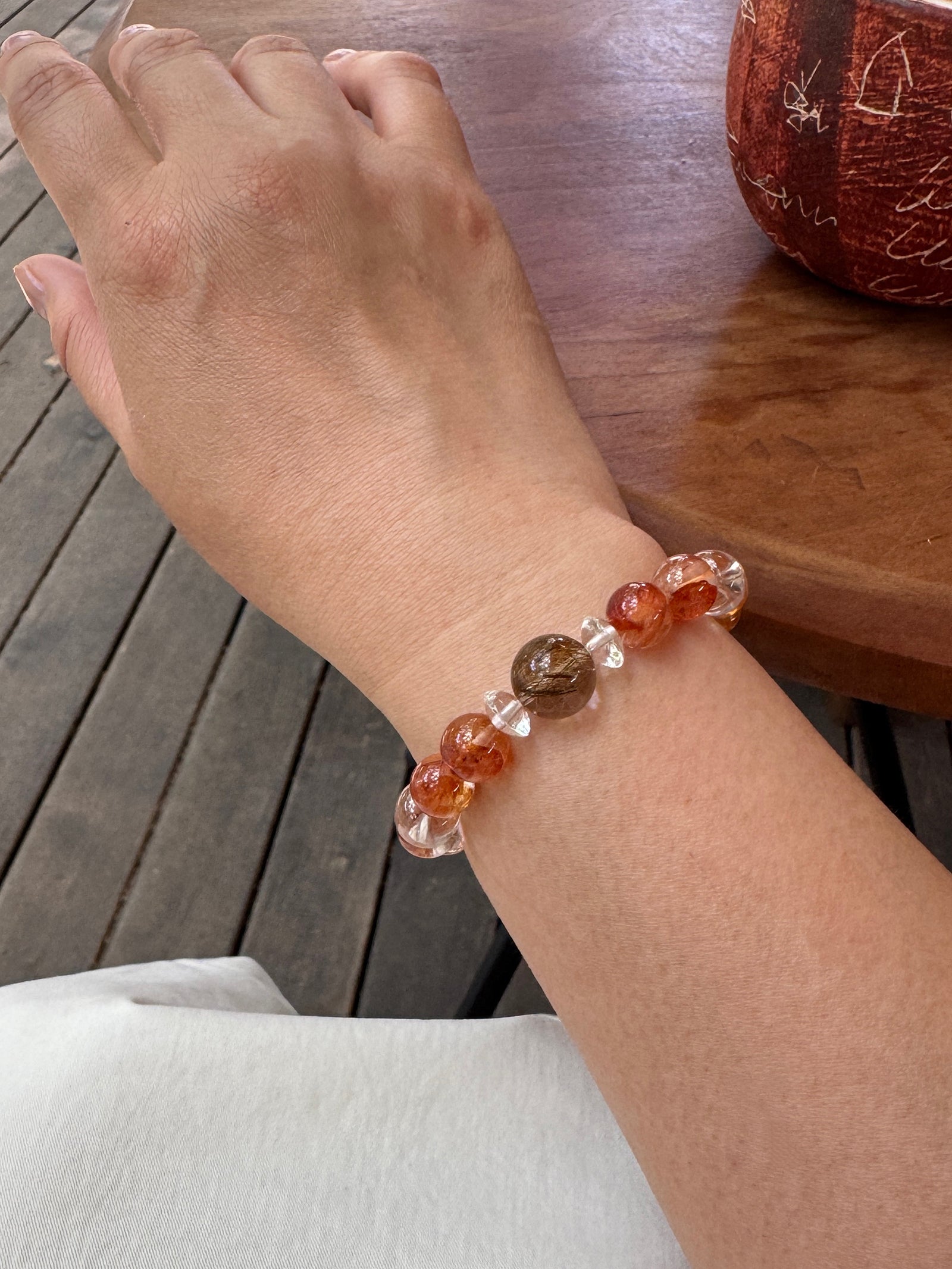 Red Flower Quartz crystal bracelet worn on wrist close-up showing size and fit