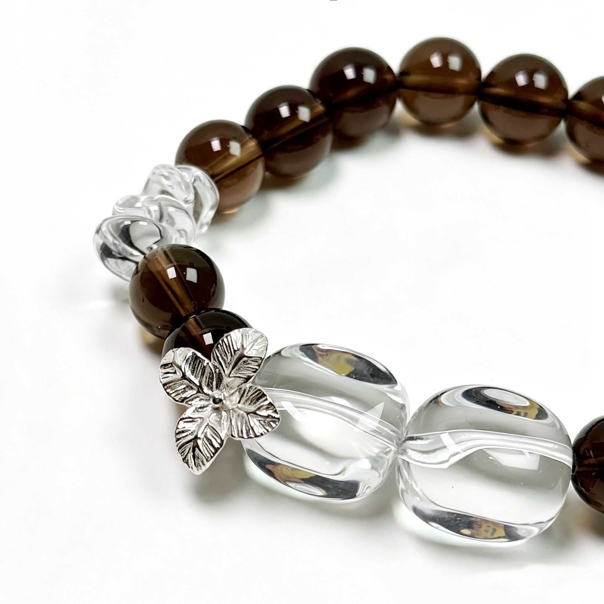 Close-up detail of Smoky Quartz and Clear Quartz bracelet showing natural texture for stability and renewal
