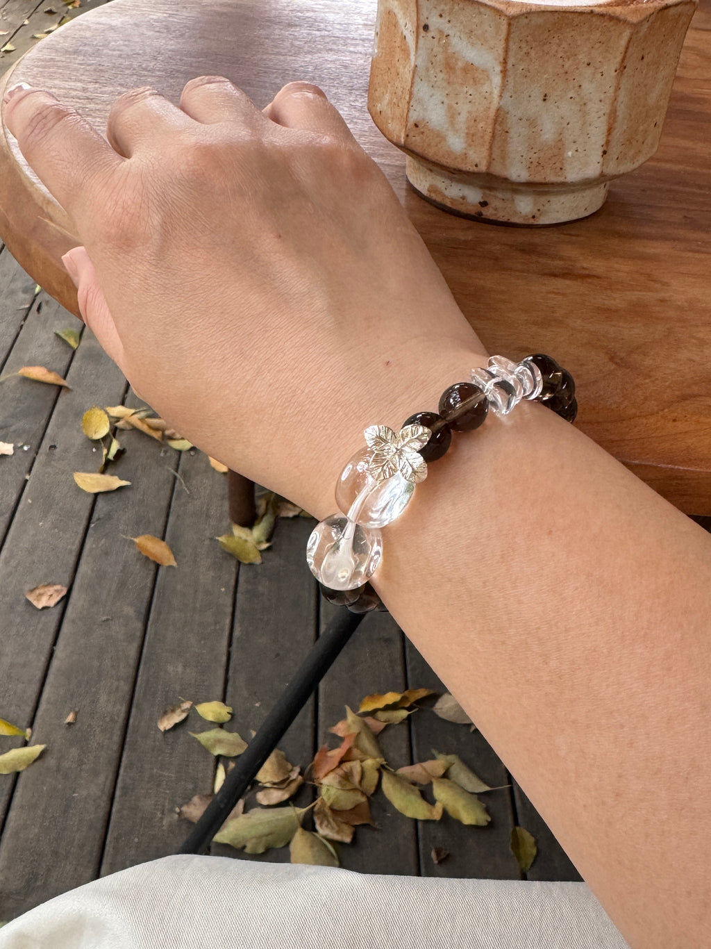 Smoky Quartz and Clear Quartz bracelet worn on wrist close-up for protection , stability and renewal
