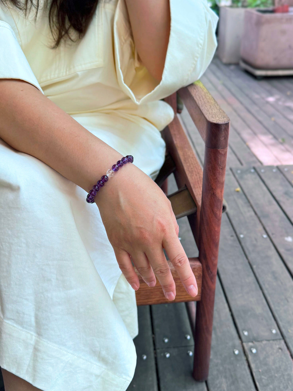 Amethyst bracelet on wrist in a café setting