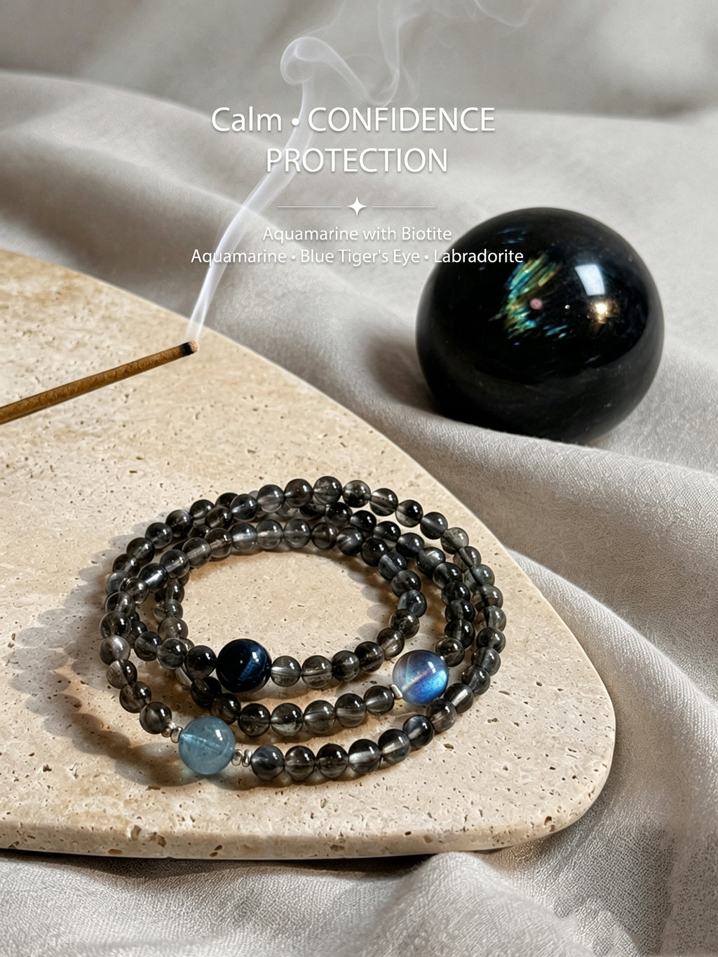 Aquamarine and Biotite crystal bracelet styled with incense and natural stone indoors