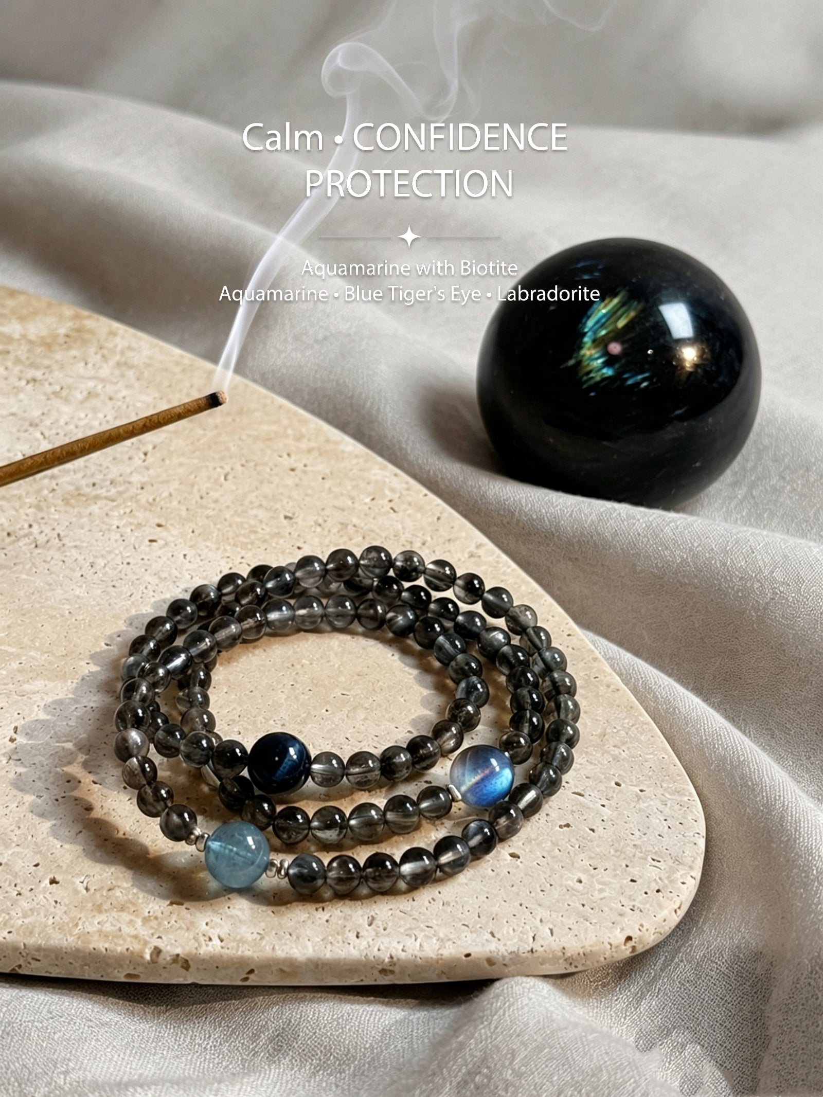 Aquamarine and Biotite crystal bracelet styled with incense and natural stone indoors