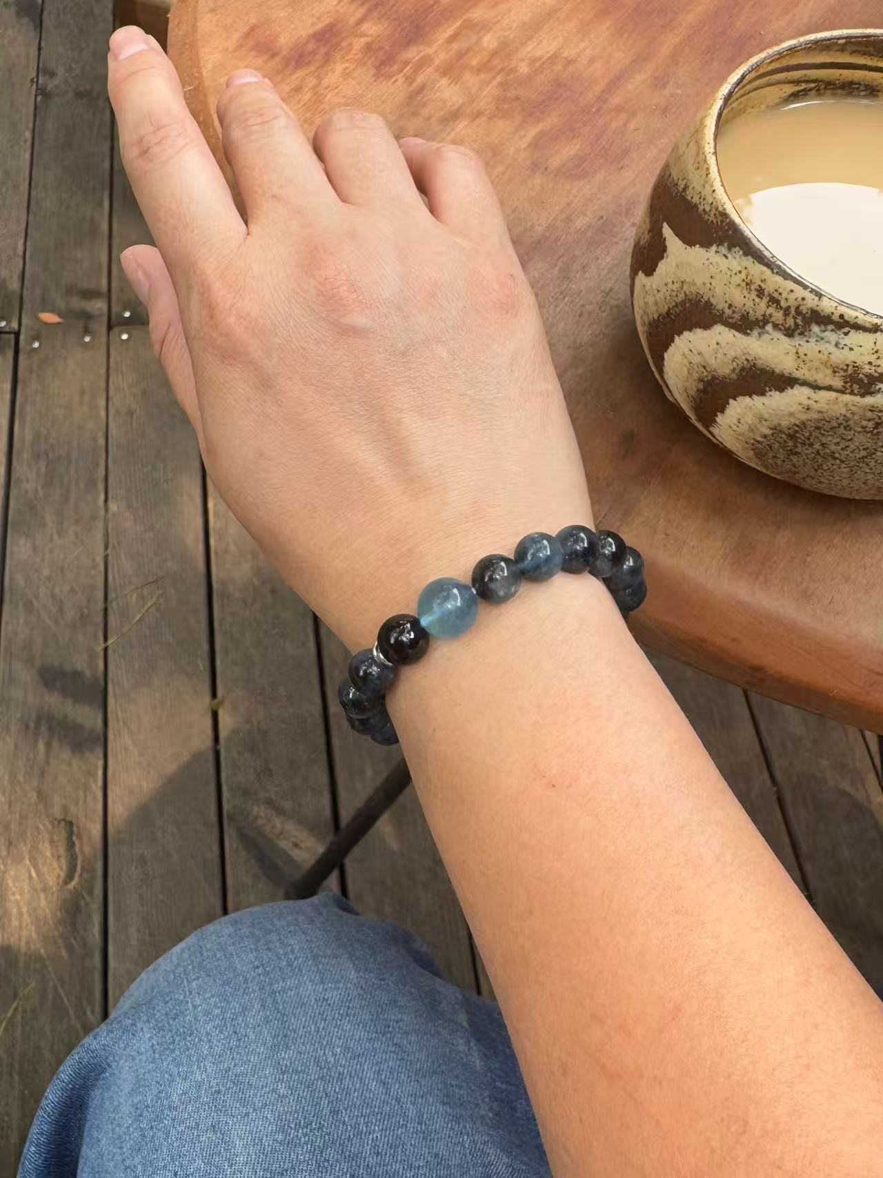 Aquamarine with Biotite crystal bracelet worn on wrist showing size and fit