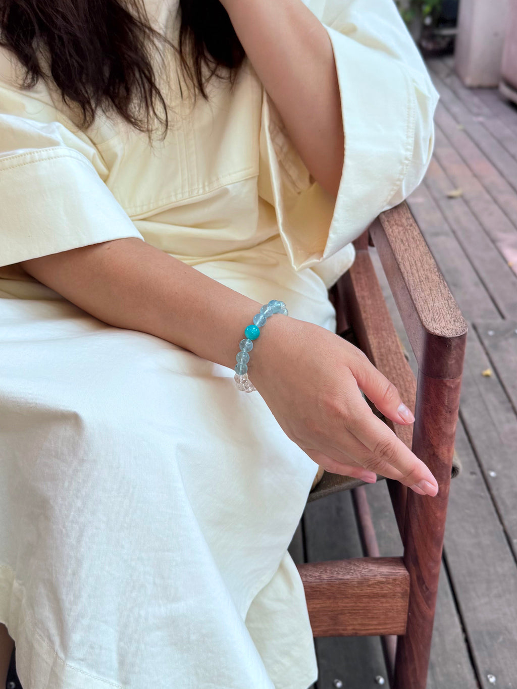 Aquamarine, Clear Quartz, and Amazonite crystal bracelet worn naturally in a calm lifestyle setting