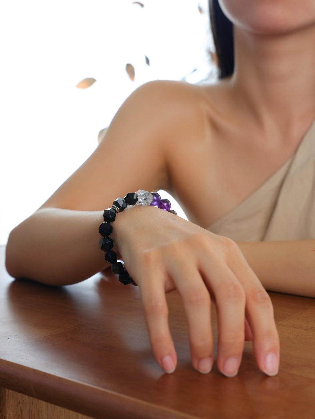 Model wearing a natural Black Obsidian, Purple Titanium Quartz and Clear Herkimer Diamond Point bracelet