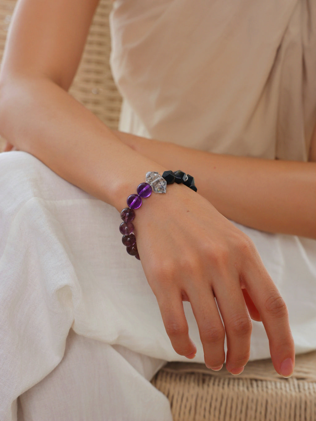 Model wearing a natural Black Obsidian, Purple Titanium Quartz and Clear Herkimer Diamond Point bracelet