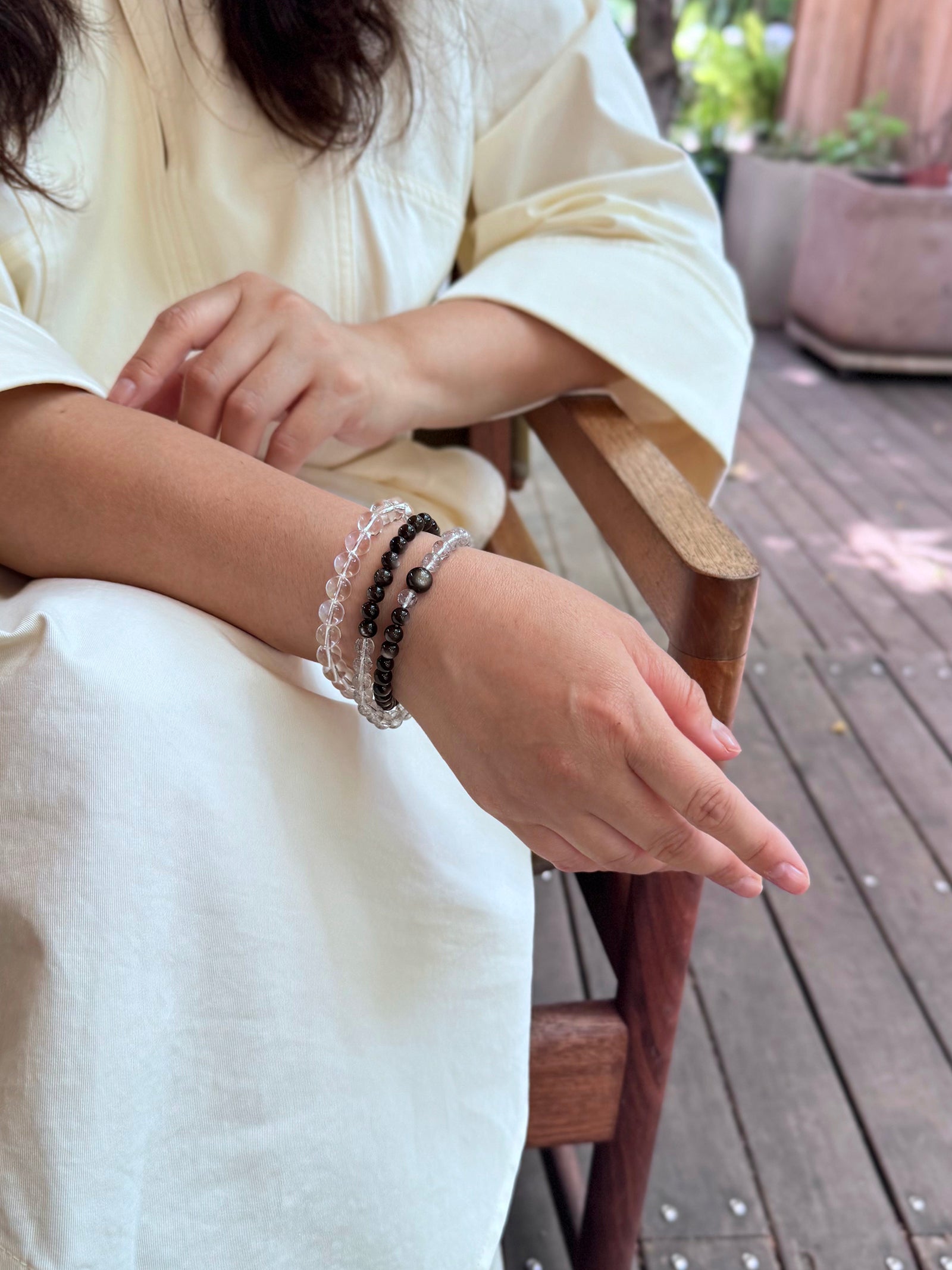 Black rutilated quartz and obsidian double wrap bracelet layered with clear quartz bracelet