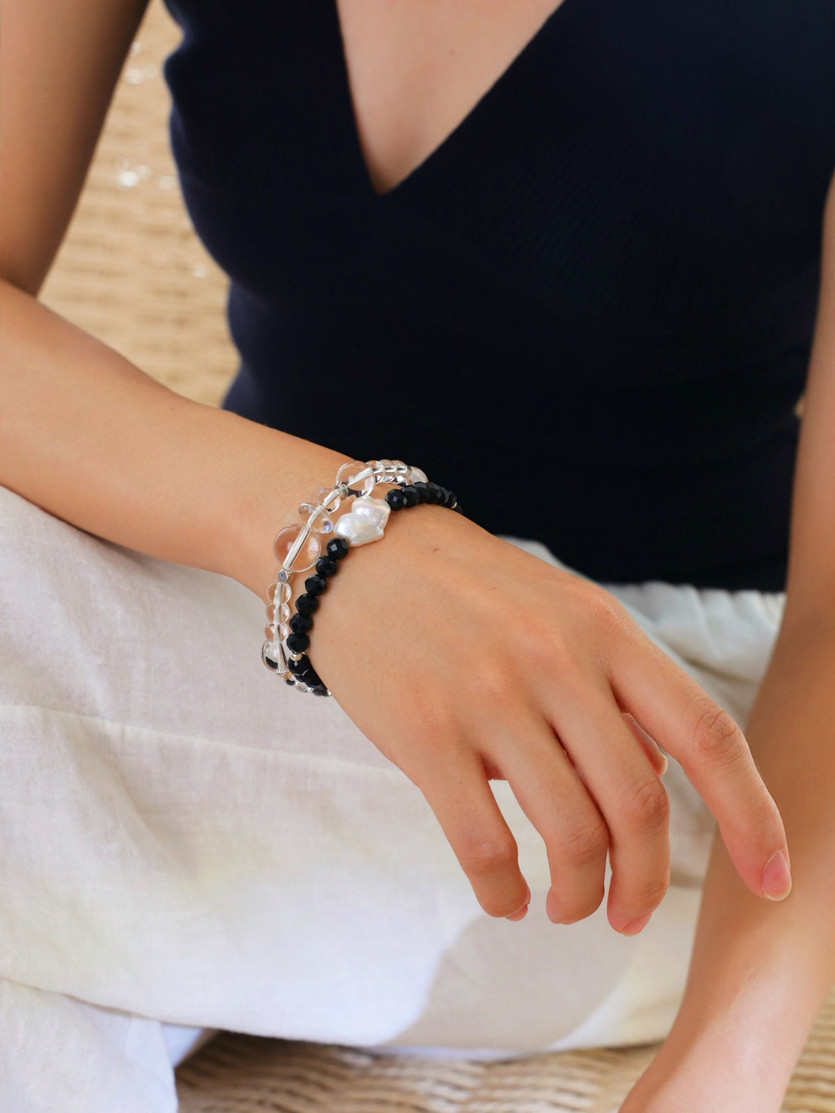 Model wearing a natural Black Spinel and Baroque Freshwater Pearl bracelet