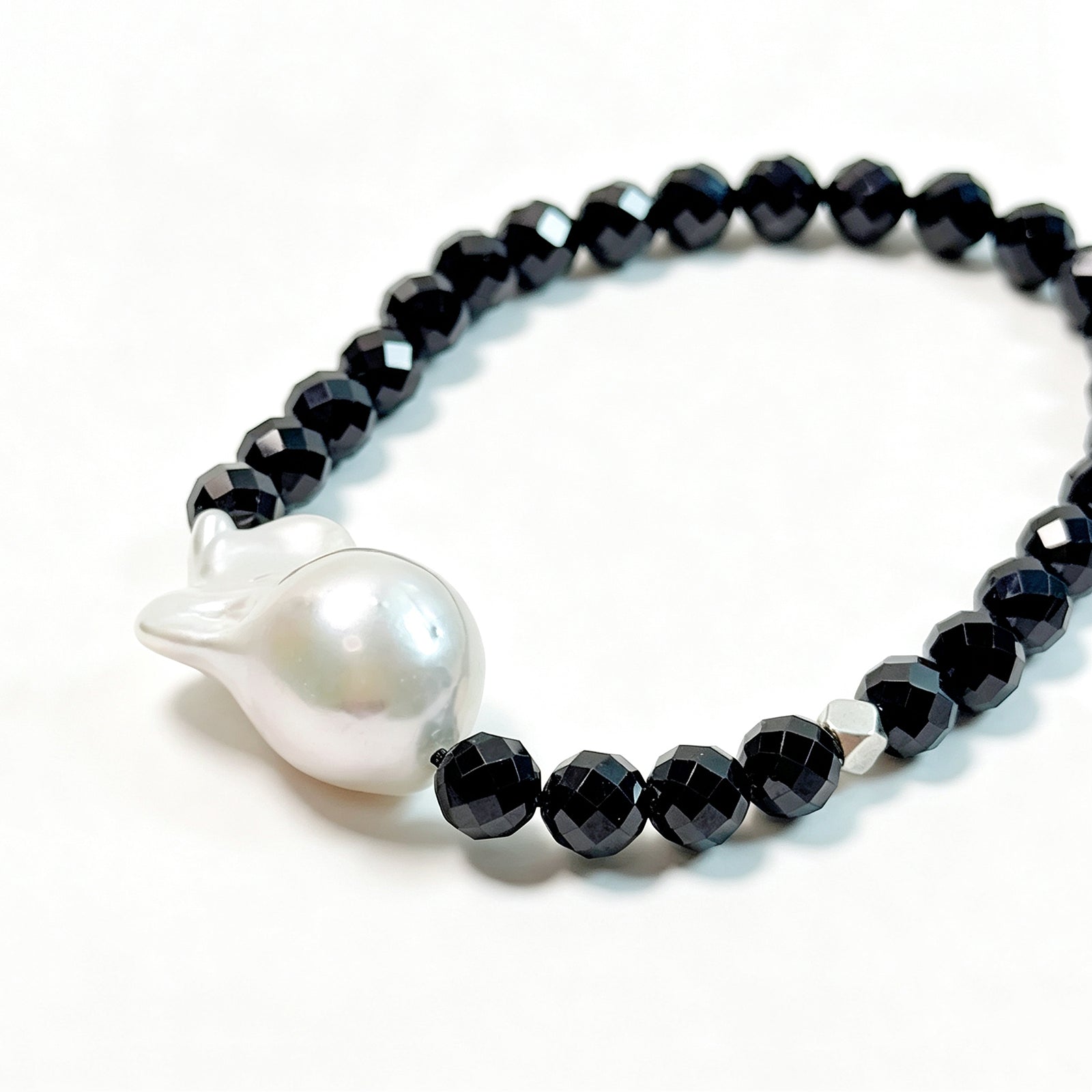 Close-up detail of black spinel and baroque freshwater pearl bracelet
