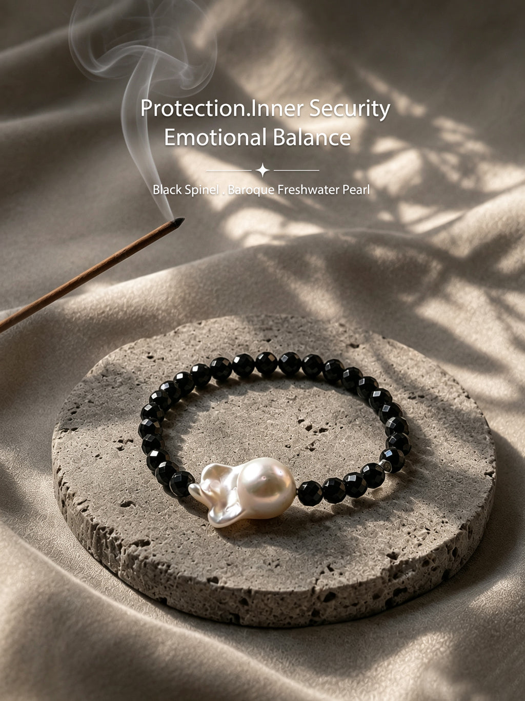 Black spinel and baroque freshwater pearl bracelet in a warm natural setting