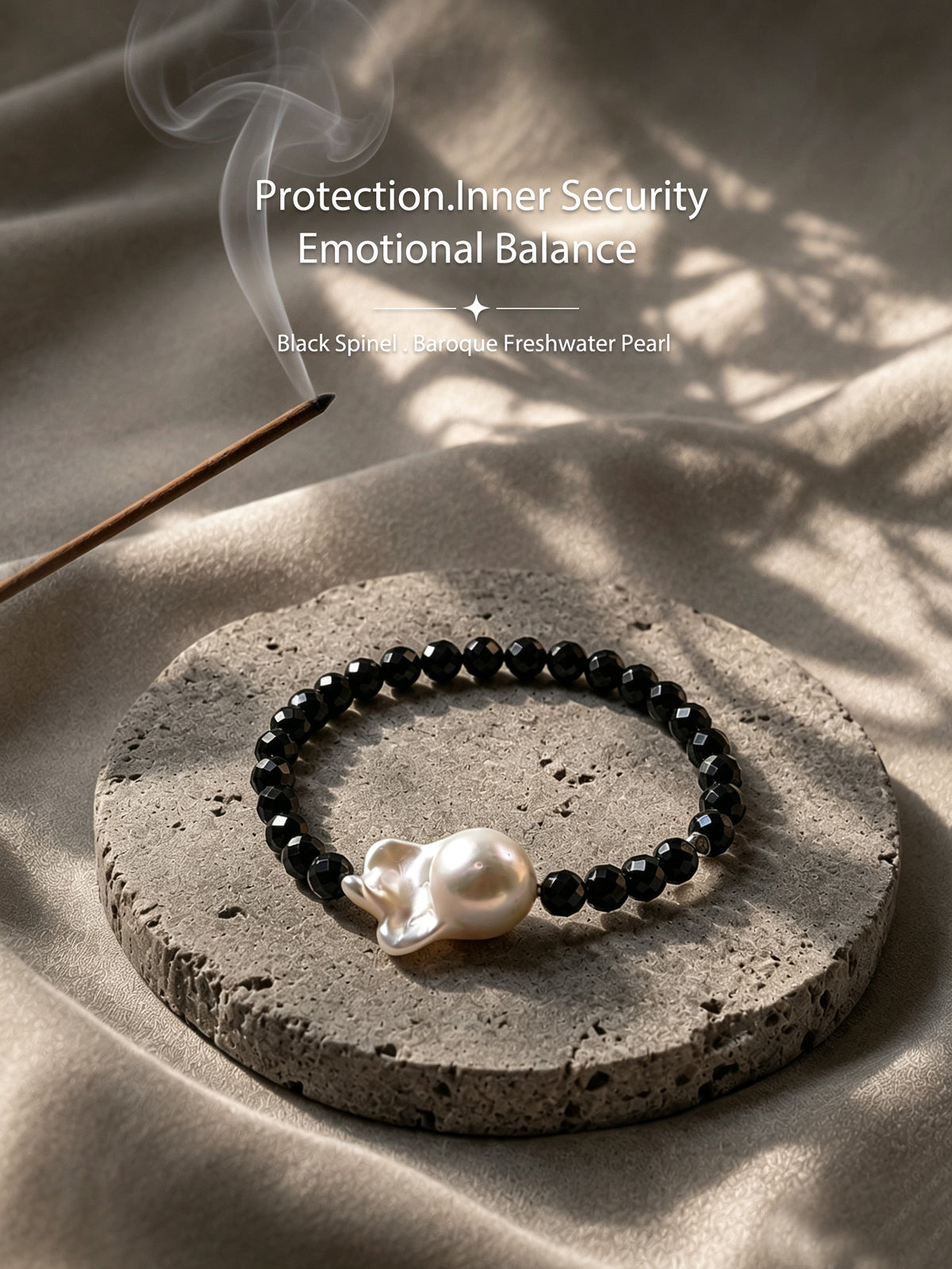 Black spinel and baroque freshwater pearl bracelet in a warm natural setting