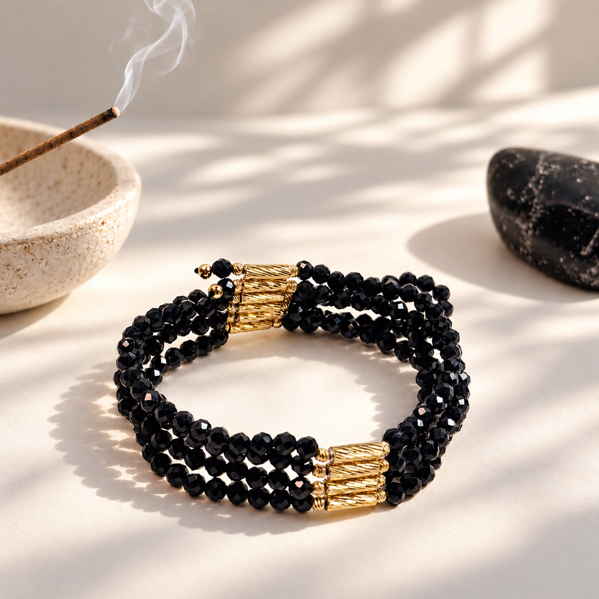 Natural undyed faceted Black Spinel convertible necklace and bracelet in an elegant jewelry lifestyle setting.
