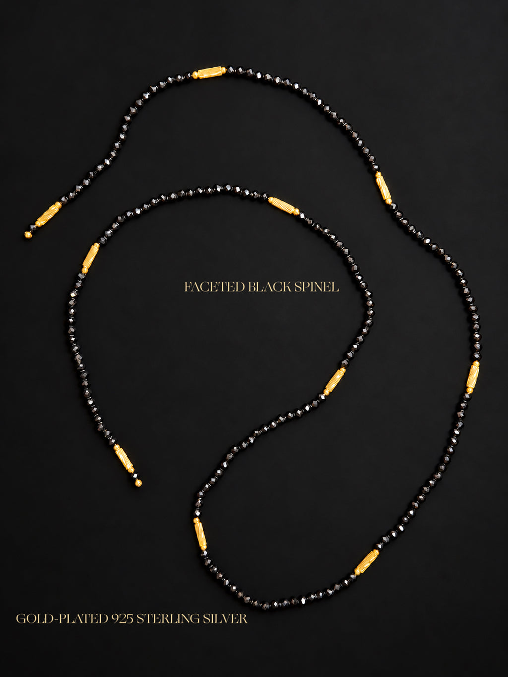 Close-up of natural undyed faceted Black Spinel beads and gold-plated 925 sterling silver magnetic clasps against a dark mineral background.