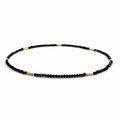 Natural undyed faceted Black Spinel convertible necklace and bracelet, side view on a pure white background.