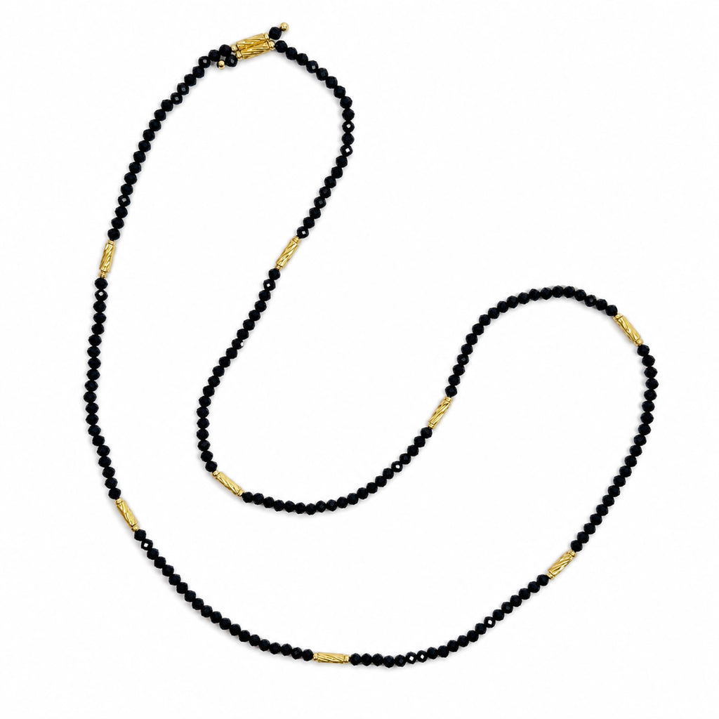 Natural undyed faceted Black Spinel convertible necklace and bracelet, top view on a pure white background.