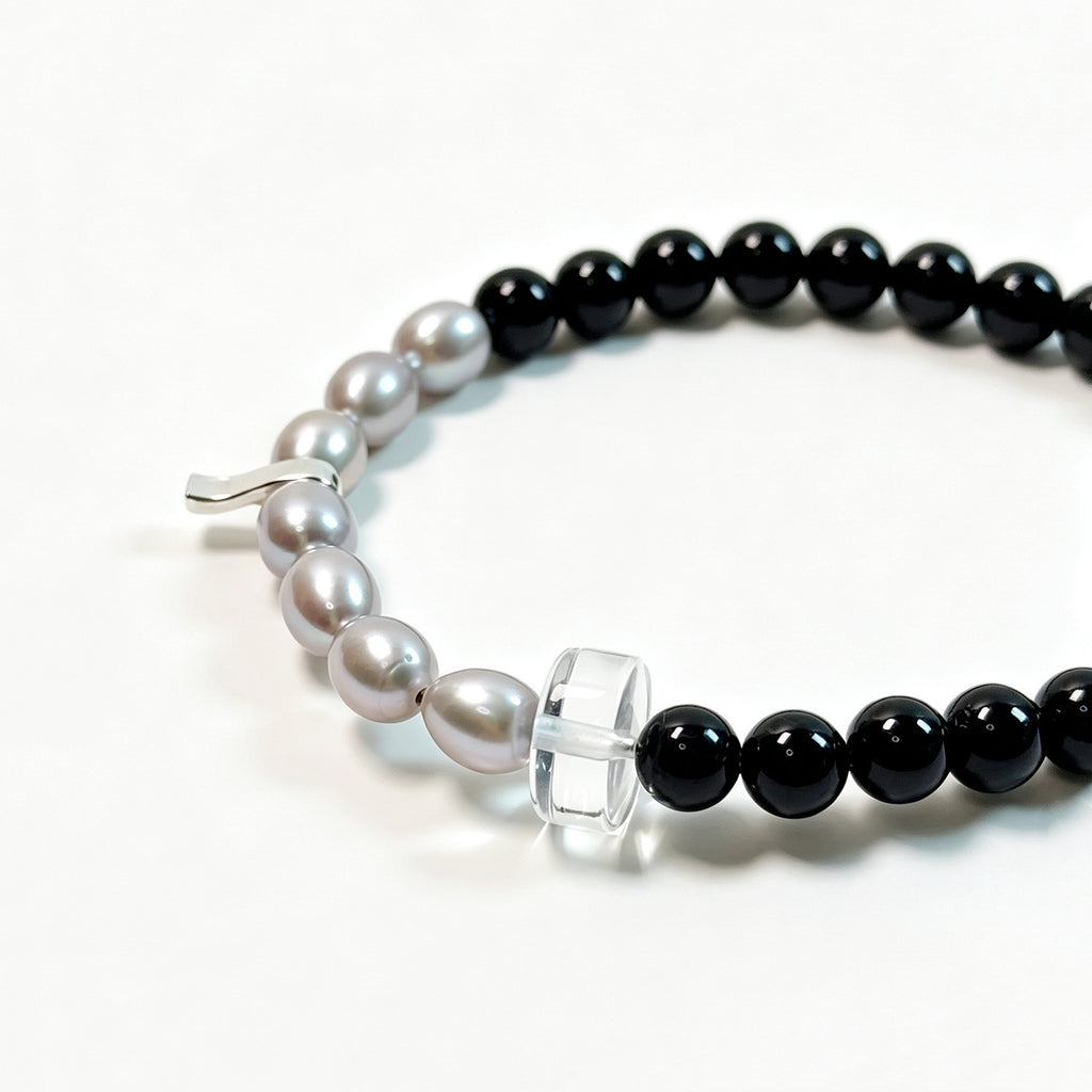  Close-up detail of black tourmaline and gray freshwater pearl bracelet
