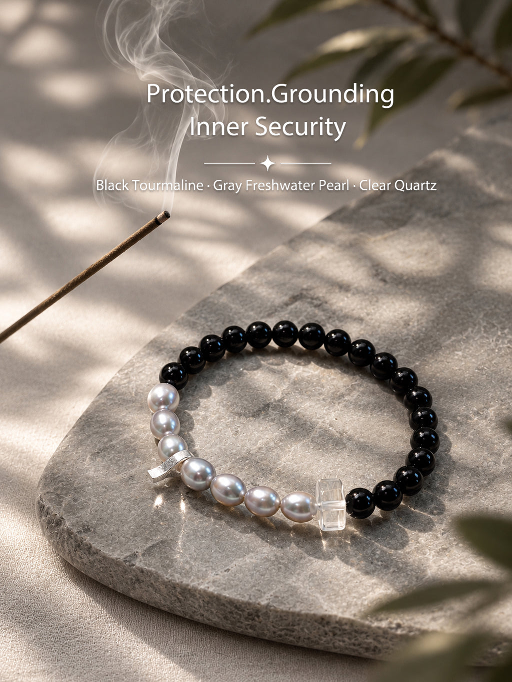 Black tourmaline and gray freshwater pearl bracelet in a natural lifestyle setting