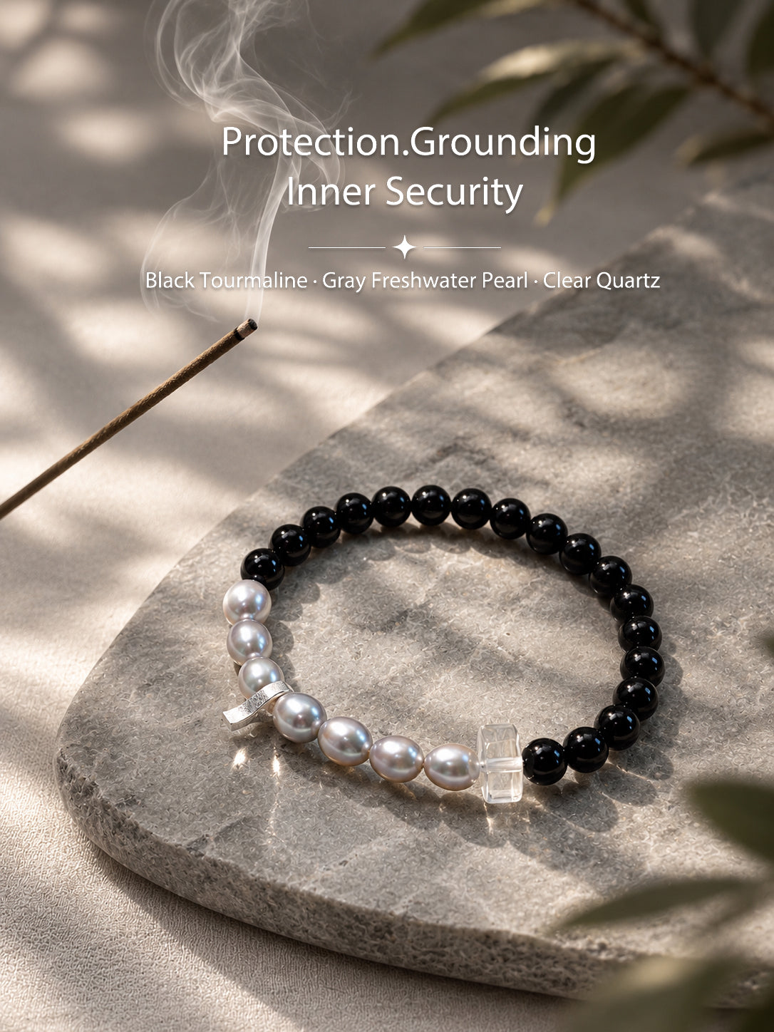 Black tourmaline and gray freshwater pearl bracelet in a natural lifestyle setting