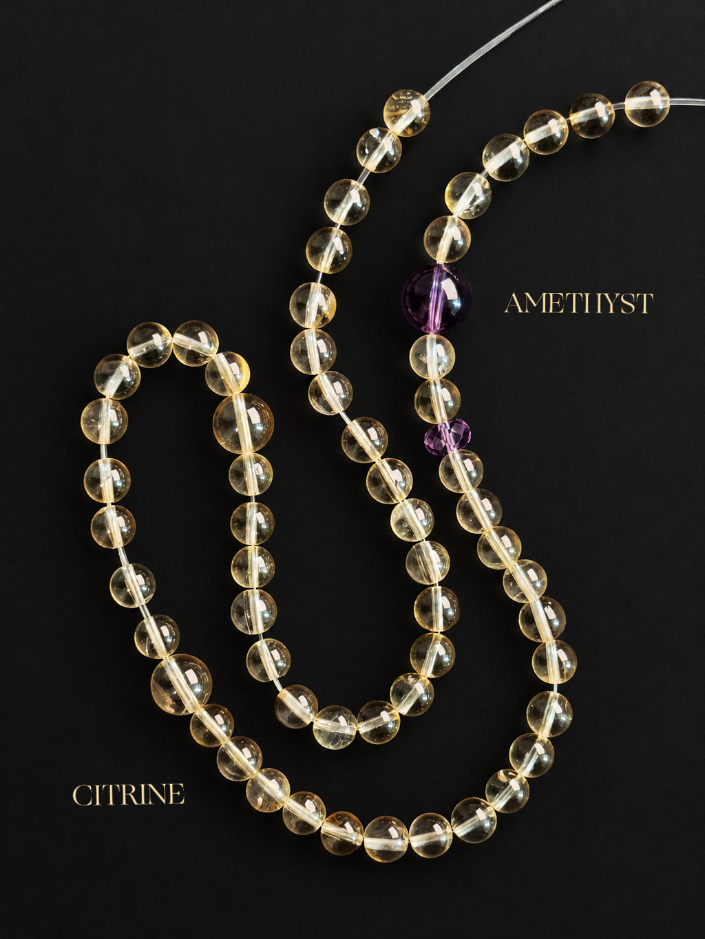High-clarity citrine and amethyst double-wrap bracelet on a dark charcoal background, showcasing translucent pale yellow citrine beads, purple amethyst accents, and natural mineral inclusions.