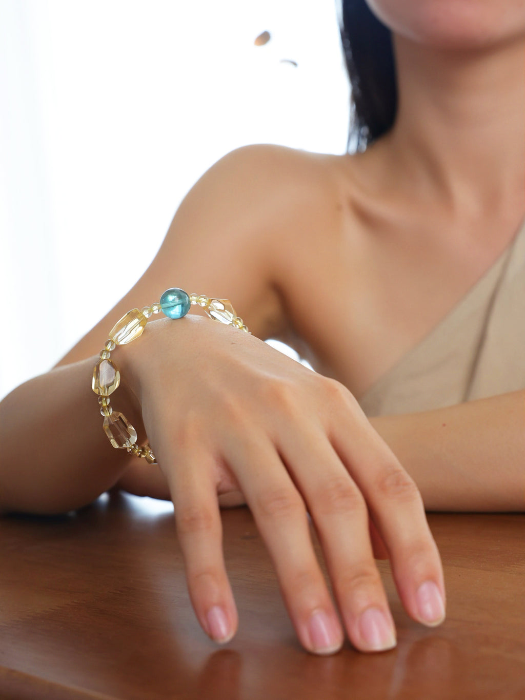 Citrine and blue-green fluorite bracelet worn on the wrist.
