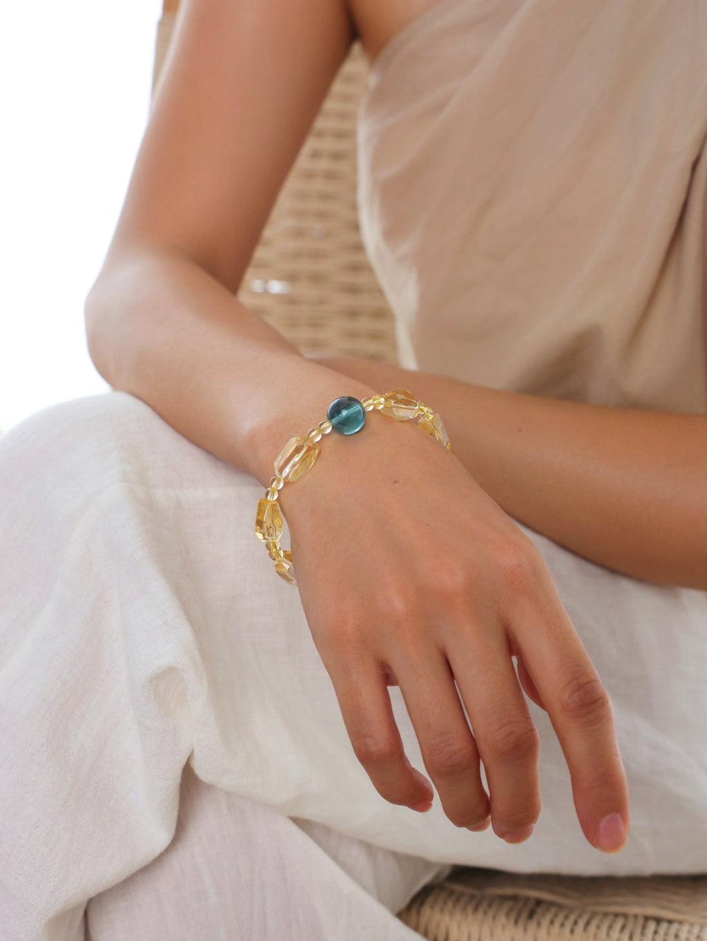 Citrine and blue-green fluorite bracelet worn on the wrist.