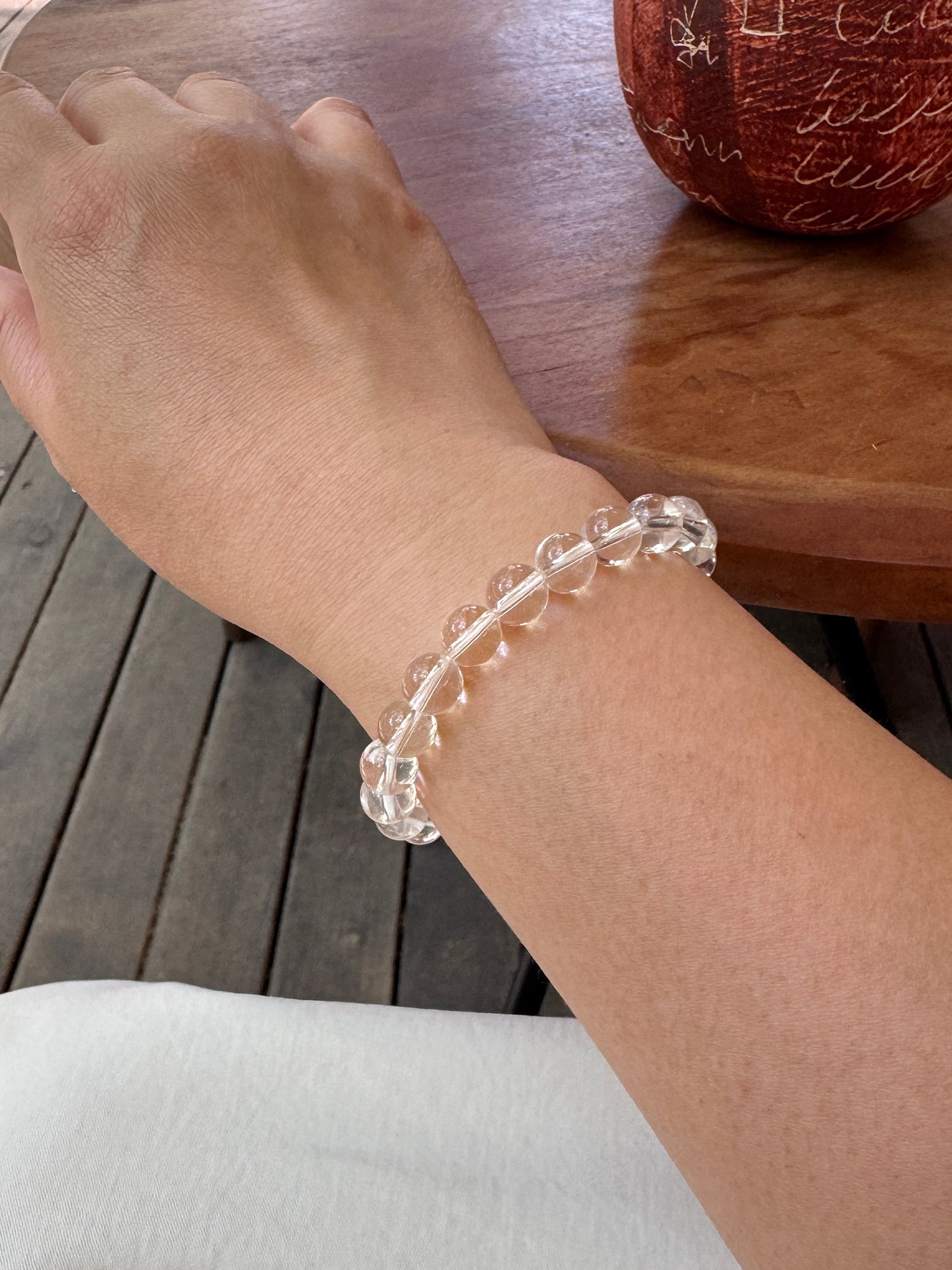 Clear quartz crystal bracelet worn on wrist close-up for renewal and emotional balance
