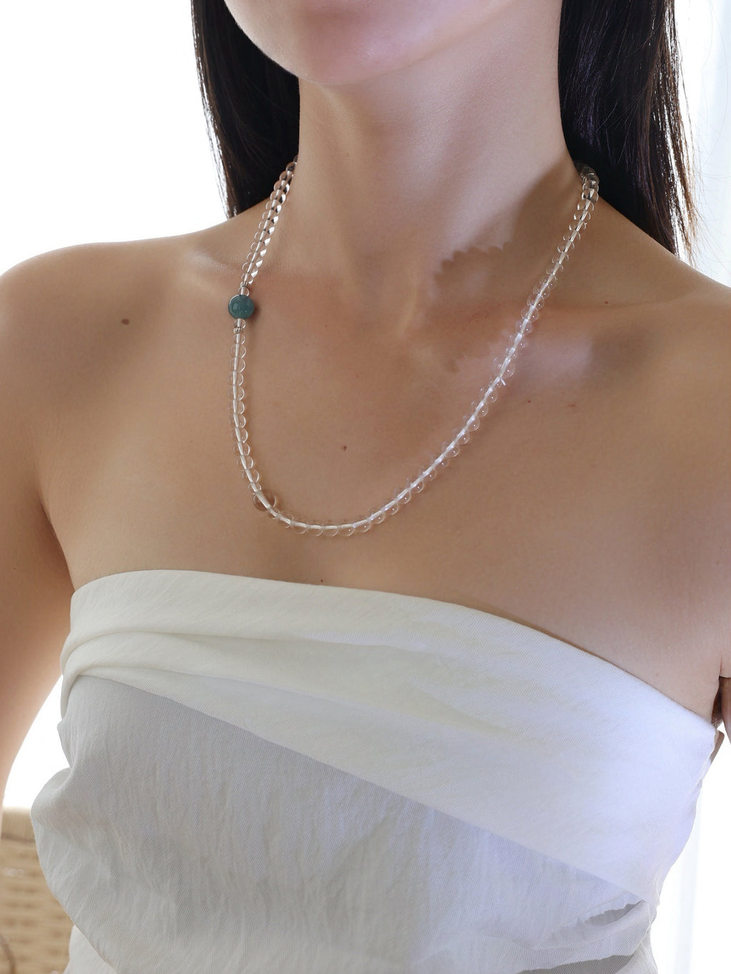 Model wearing a collector-grade Clear Quartz and Monet Blue-Green Kyanite single-strand necklace with 925 sterling silver.
