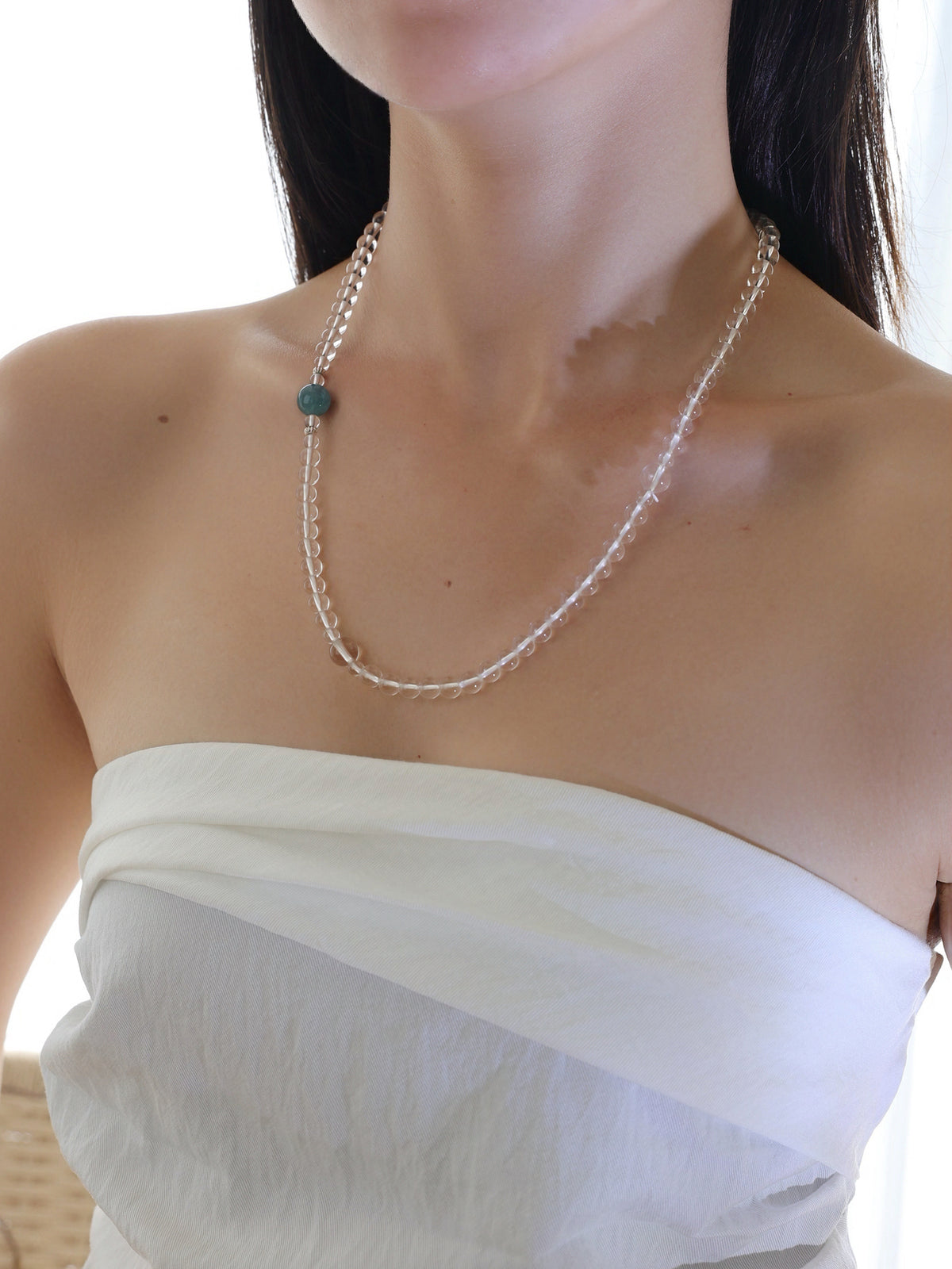 Model wearing a collector-grade Clear Quartz and Monet Blue-Green Kyanite single-strand necklace with 925 sterling silver.
