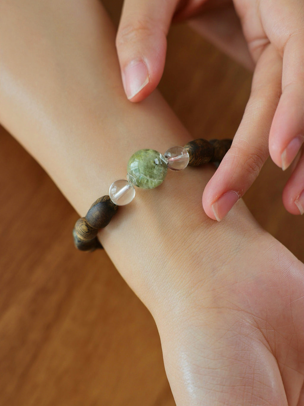 Collector’s Grade Green Phantom, Natural Agarwood and Clear Quartz bracelet worn on wrist