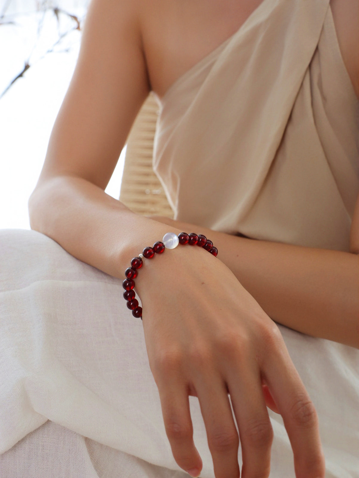 Model wearing a natural Deep Burgundy Garnet and Moonstone bracelet