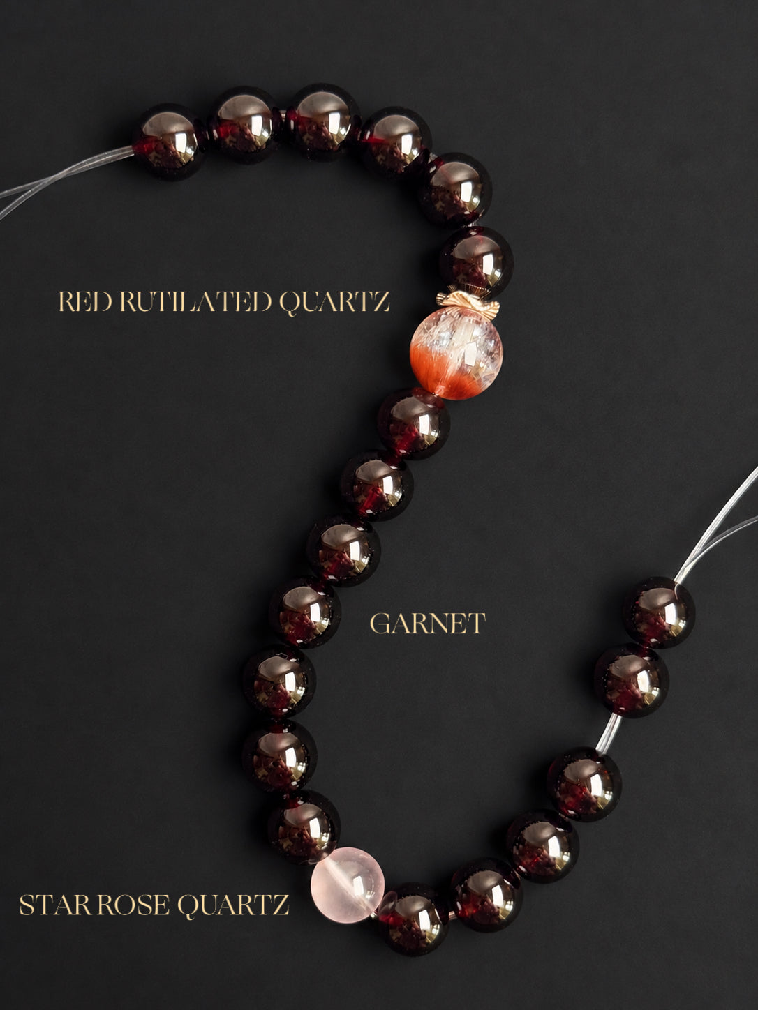 Fine Garnet, Pink Rabbit Hair Quartz and Rose Quartz bracelet displayed on a black mineral background, highlighting the natural gemstone colors, clarity and inclusions.