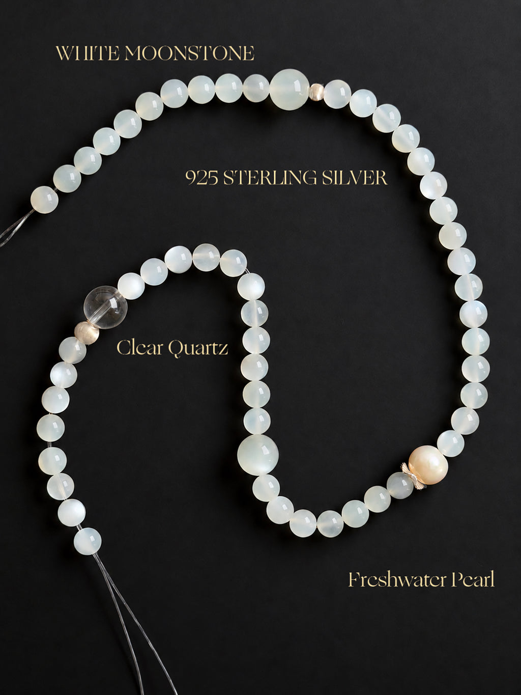 Fine White Moonstone, Clear Quartz and Freshwater Pearl double wrap bracelet displayed against a black background, highlighting the natural gemstone textures, translucency, pearlescent luster and delicate details.
