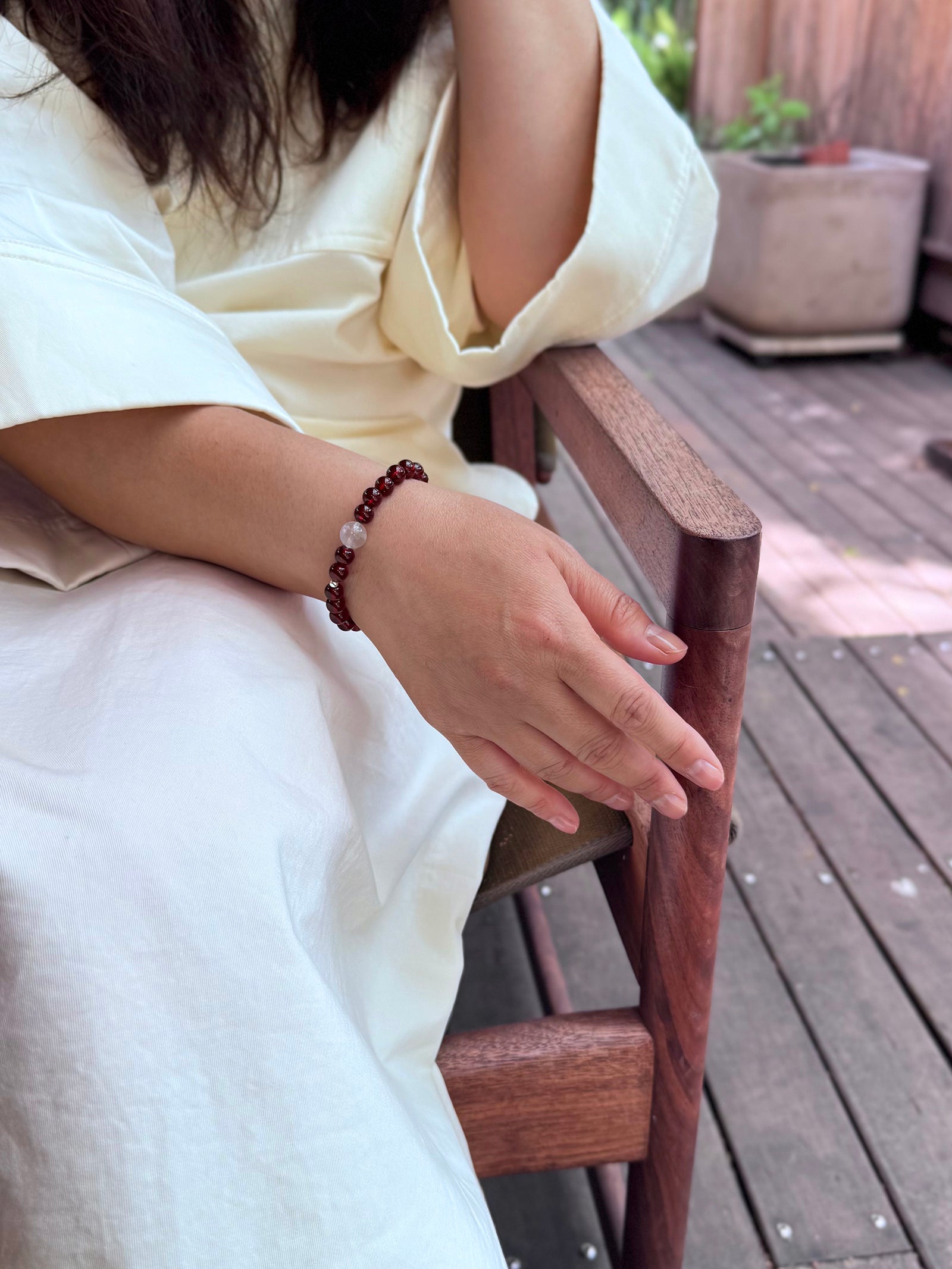 Garnet and moonstone bracelet worn in relaxed natural lifestyle setting showing everyday wearability
