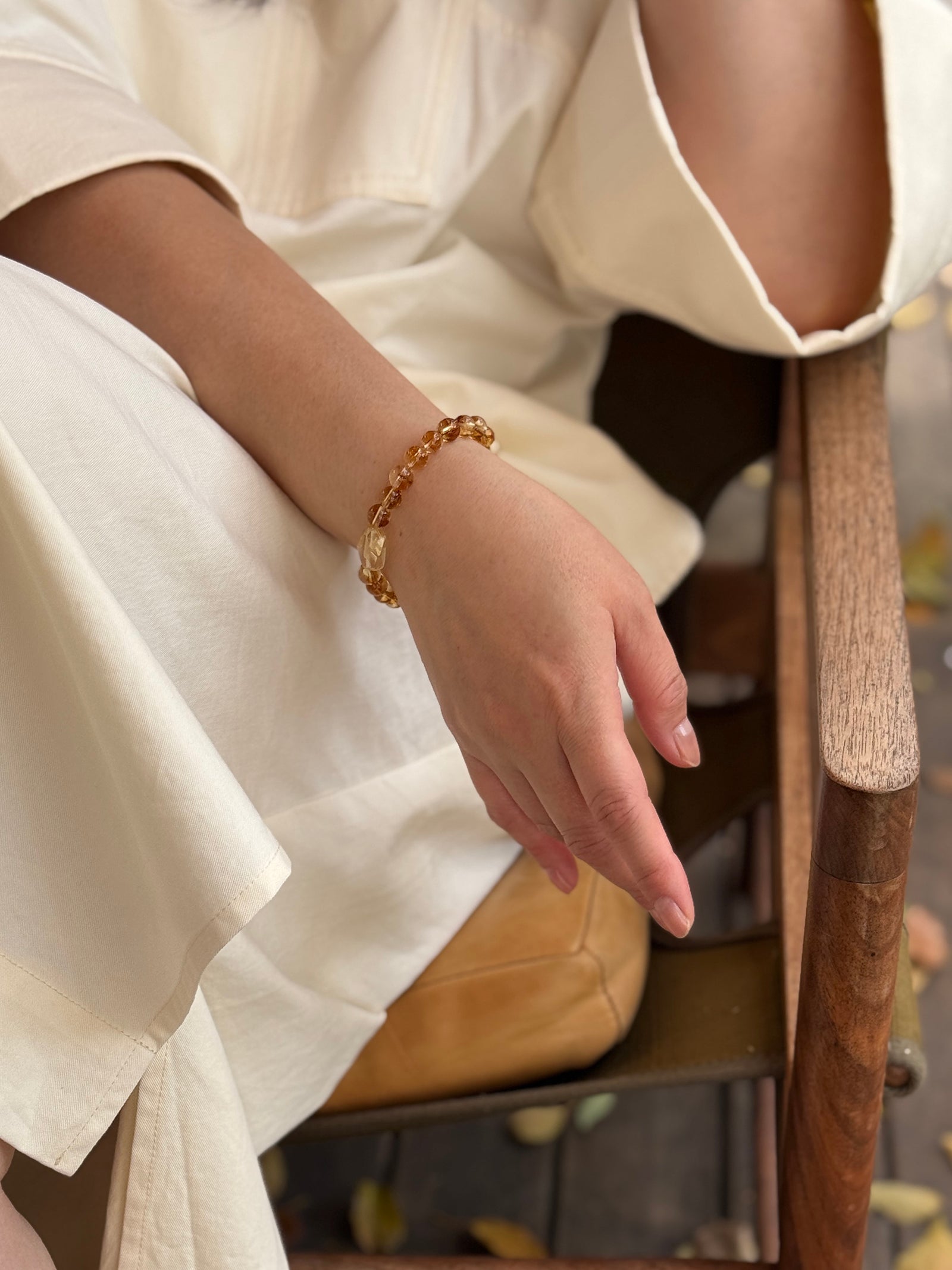 Golden healer Quartz crystal bracelet worn in a relaxed lifestyle setting for calm and balanced energy