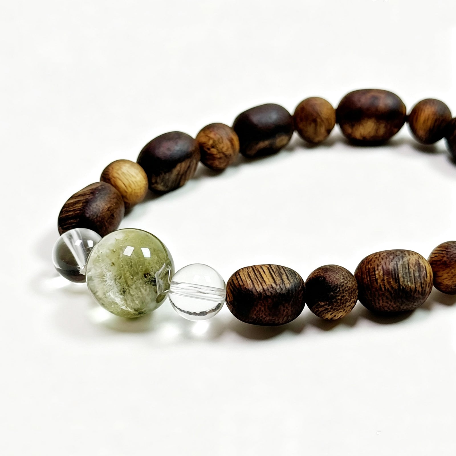 
Close-up detail of Green Phantom and Natural Agarwood bracelet showing natural crystal and wood texture