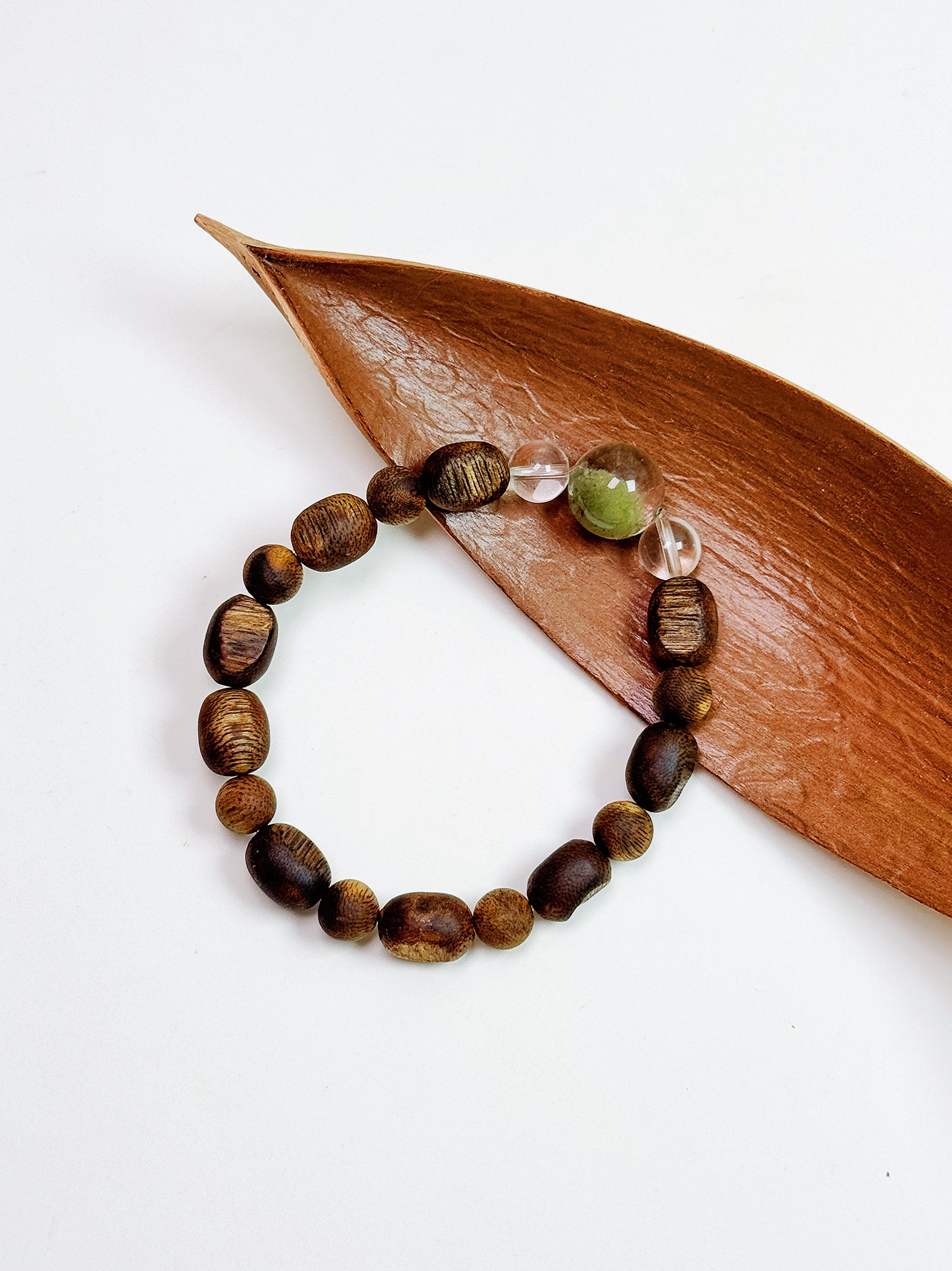 Green Phantom and Natural Agarwood bracelet styled in a peaceful artistic setting