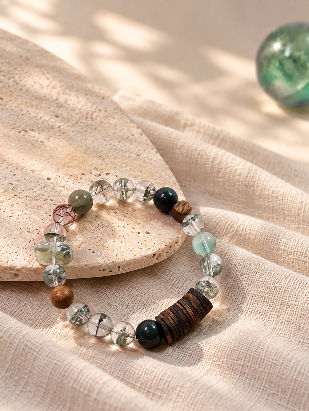Green Phantom crystal bracelet styled with natural agarwood and calming spiritual objects