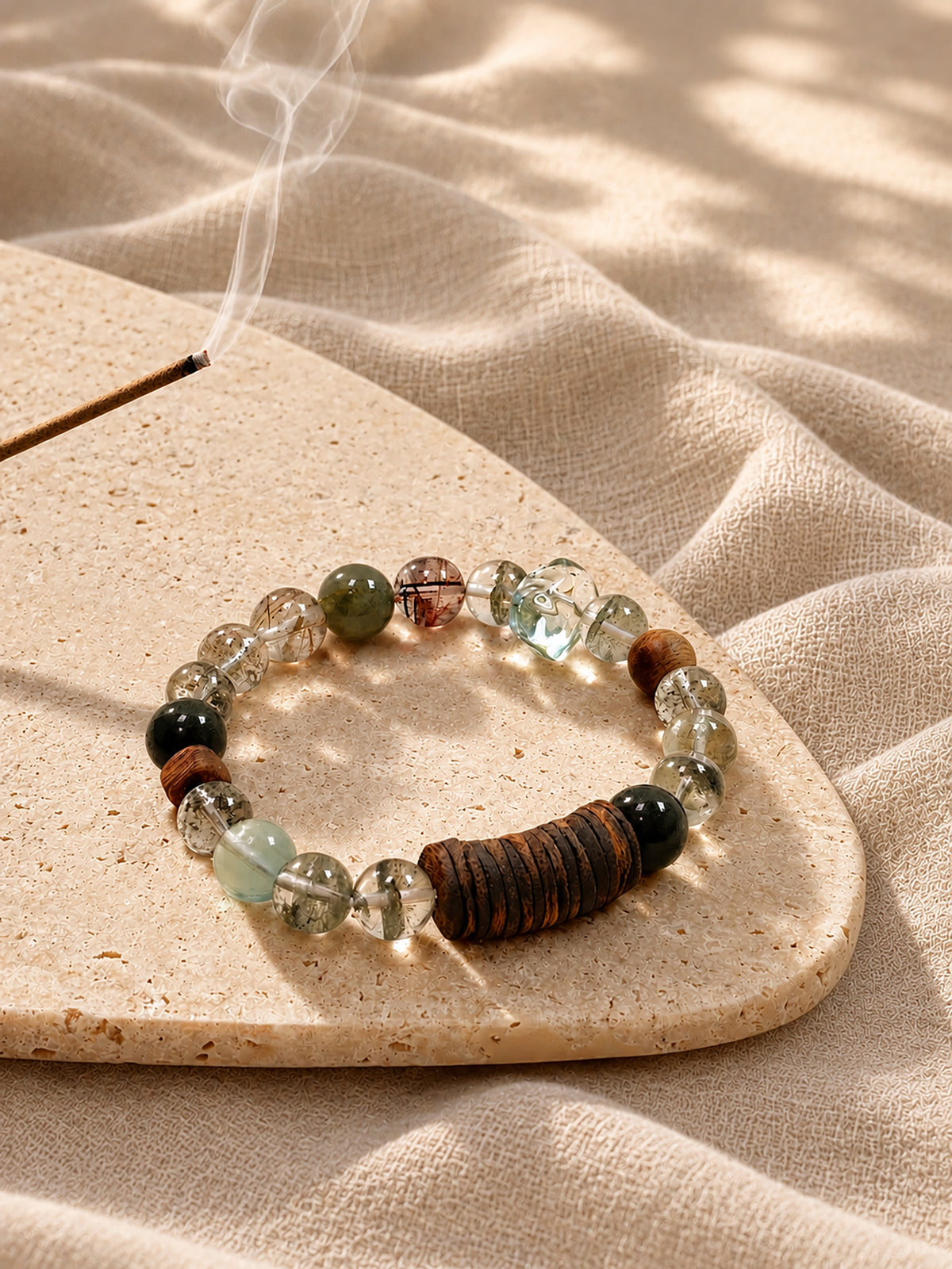 Green Phantom crystal bracelet styled with natural agarwood and calming spiritual objects