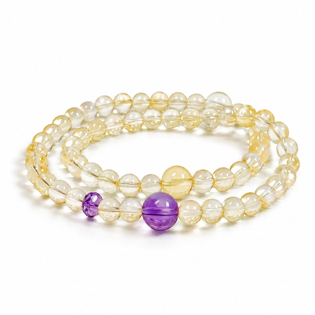 High-clarity citrine and amethyst double-wrap bracelet featuring translucent pale yellow crystal beads and purple amethyst accents on a white background.