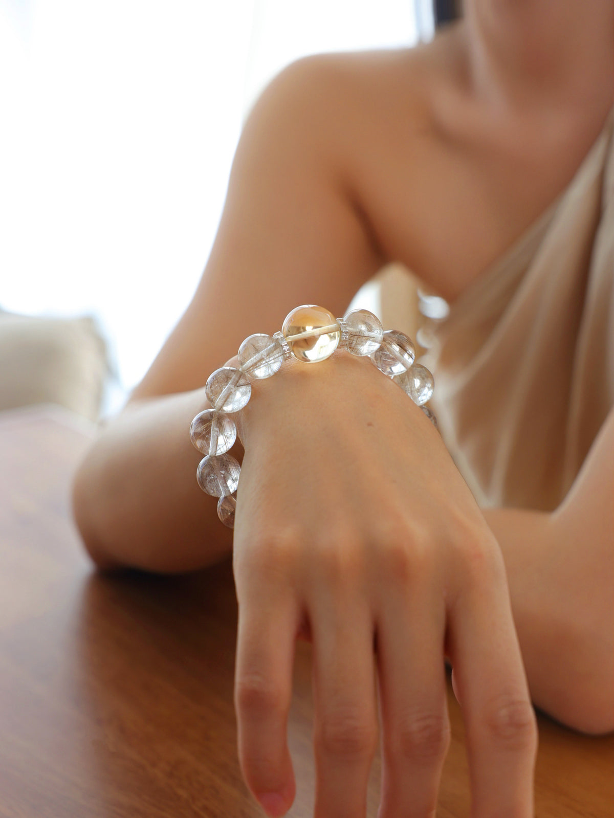 Model wearing a natural High-Clarity Silver Rutilated Quartz and Collector-Grade Citrine bracelet