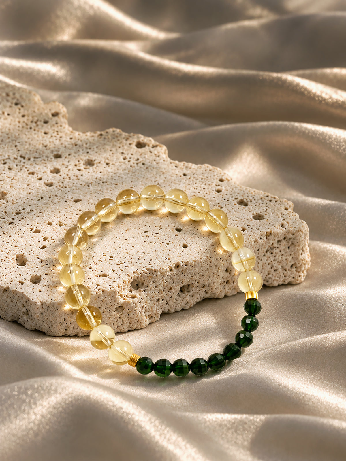 High-grade citrine and emerald-green diopside crystal bracelet photographed in soft natural light, showcasing its warm golden and vibrant green gemstones.