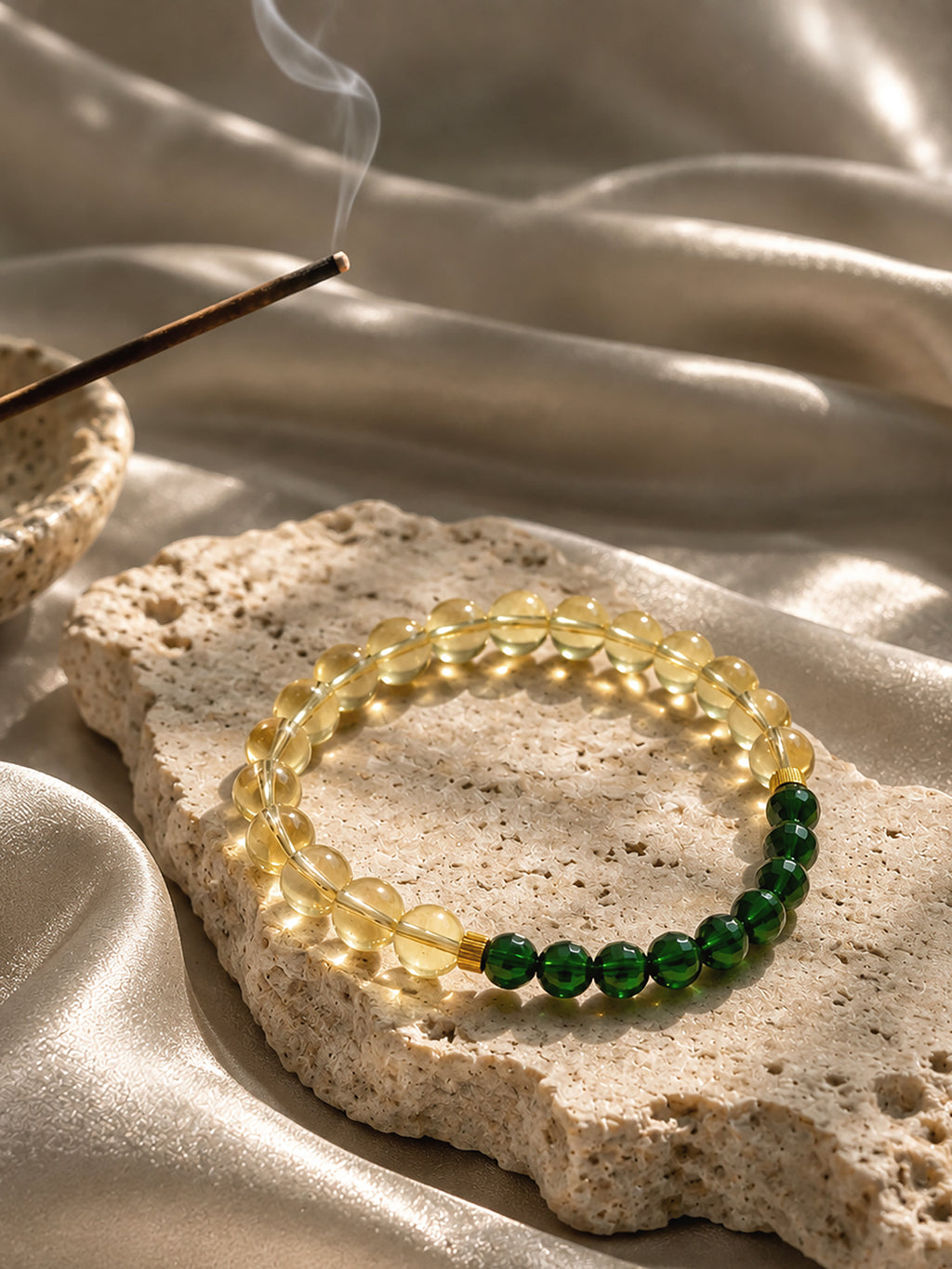High-grade citrine and emerald-green diopside crystal bracelet photographed in soft natural light, showcasing its warm golden and vibrant green gemstones.