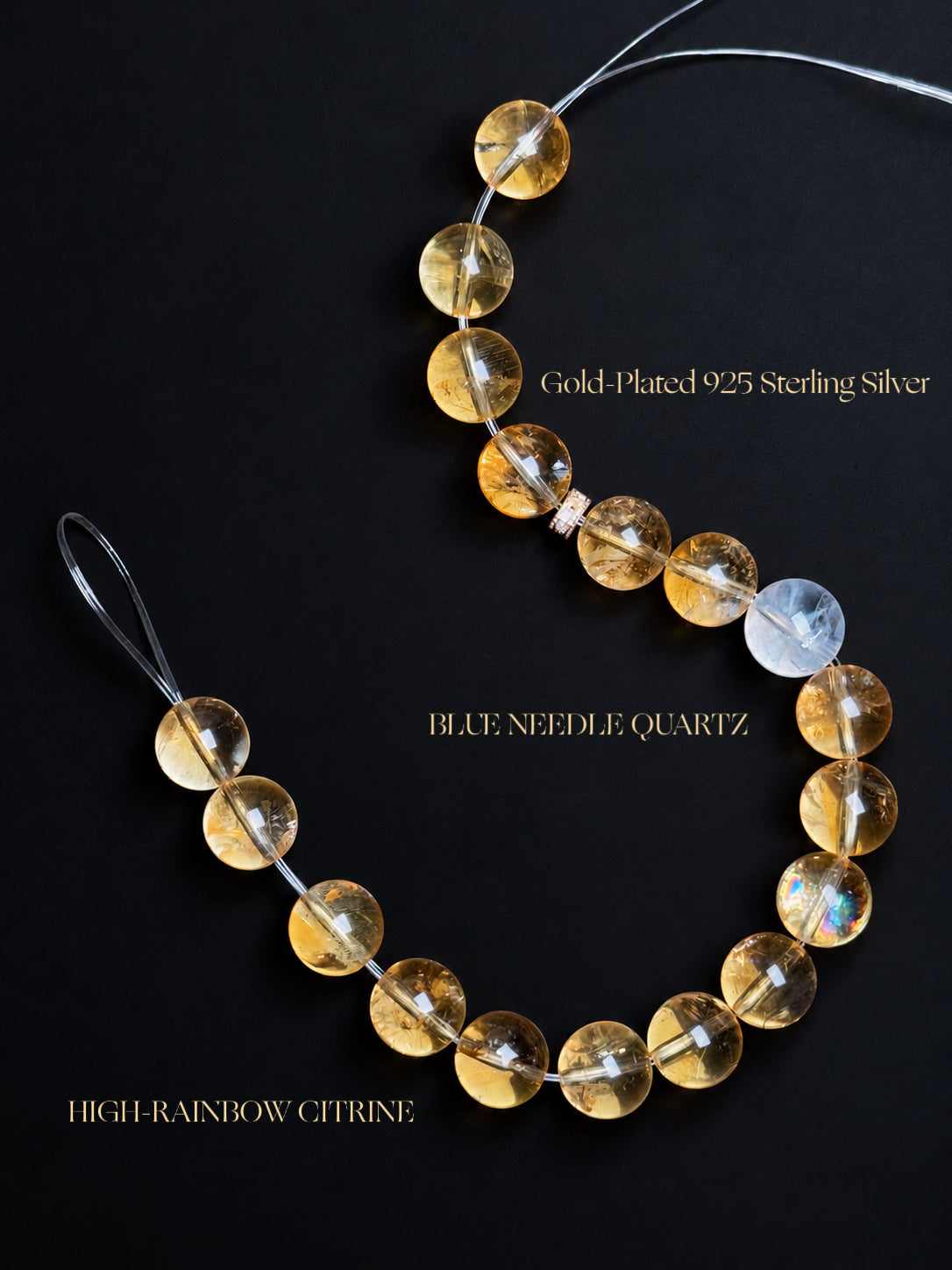 High-Rainbow Citrine and Blue Needle Quartz bracelet featuring translucent honey-gold beads with natural rainbow flashes, fingerprint-like internal fractures, delicate blue needle inclusions, and gold-plated 925 sterling silver accents against a dark background.