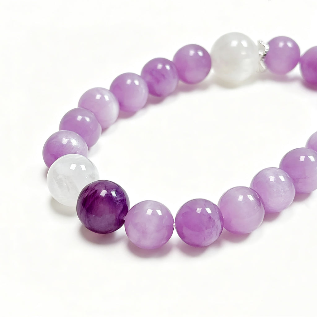 Close-up of a natural Kunzite, Charoite & White Phantom Quartz bracelet highlighting the natural stone textures